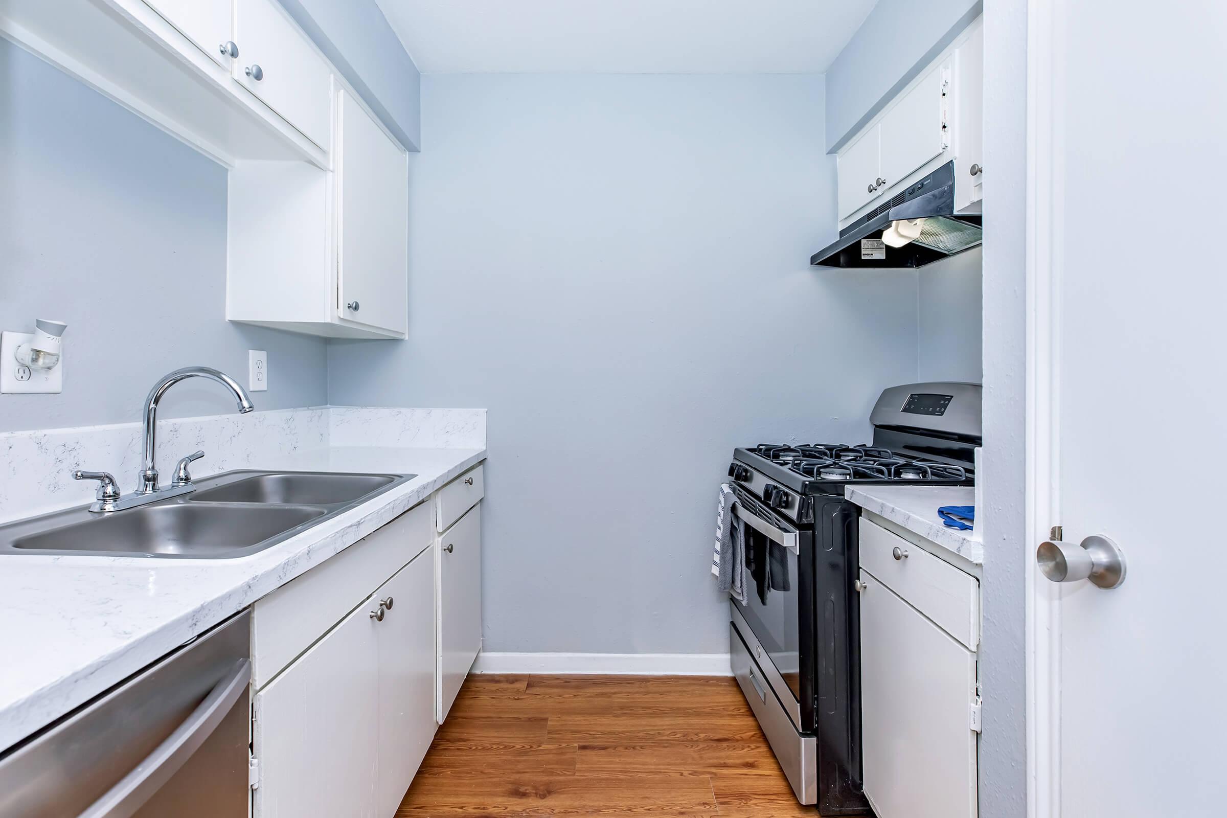 a kitchen with a stove and a sink