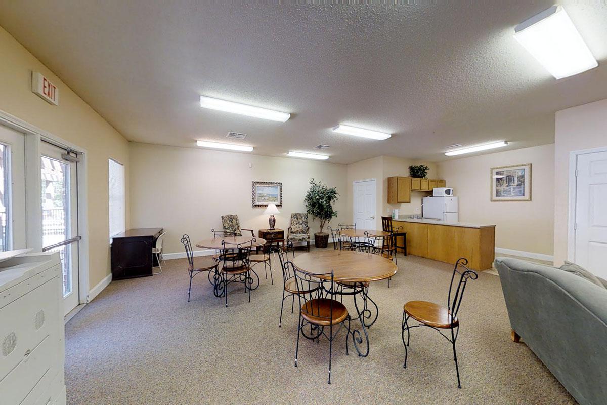 a living room filled with furniture and a large window