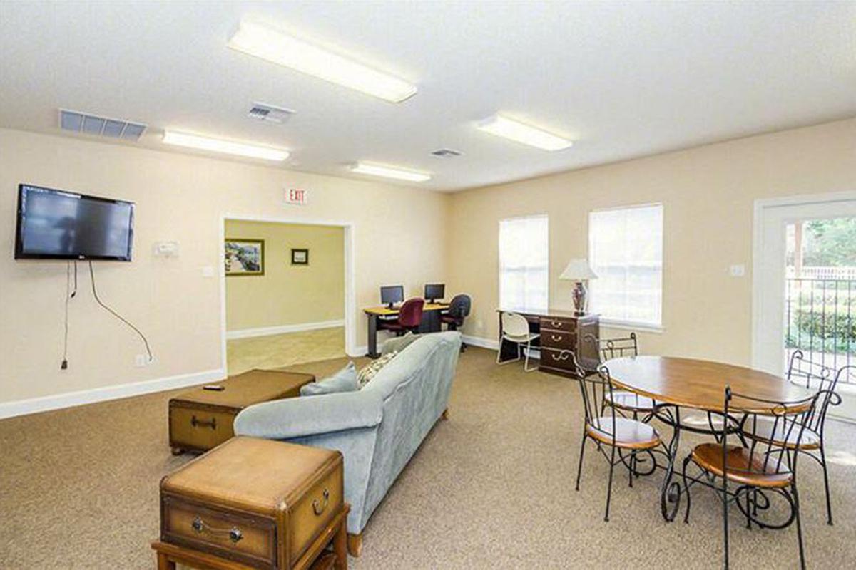 a living room filled with furniture and a tv