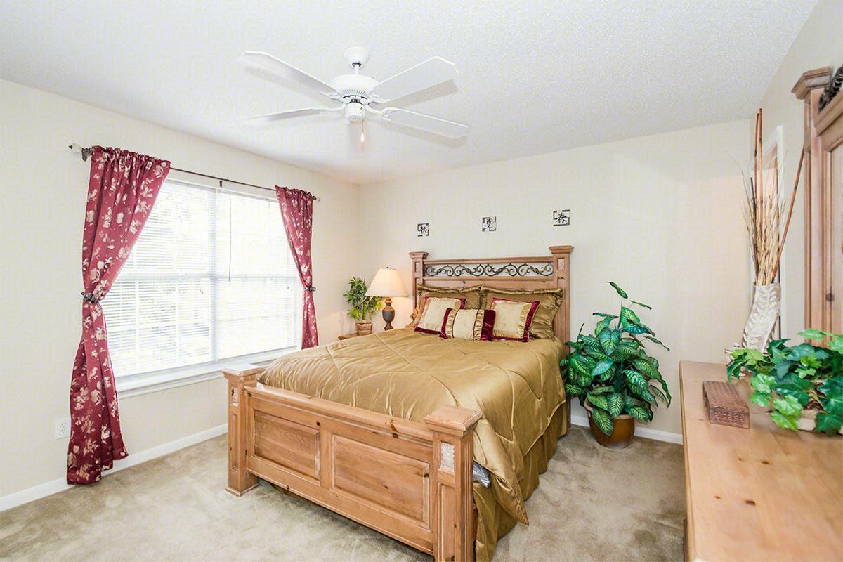 a living room filled with furniture and a bed