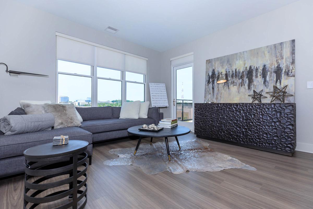 a living room filled with furniture and a large window