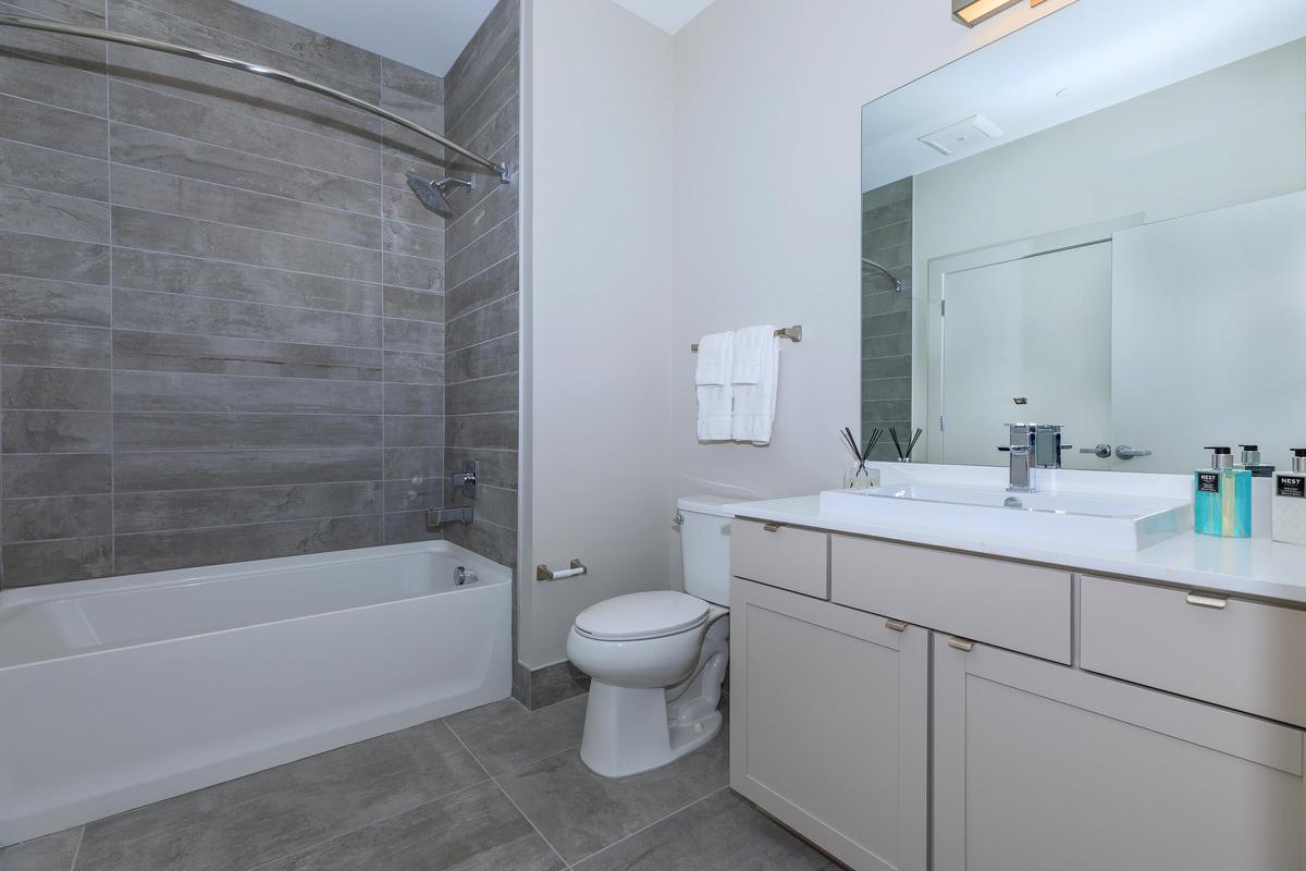 a white sink sitting next to a shower