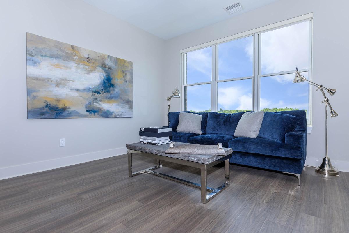 a living room filled with furniture and a large window