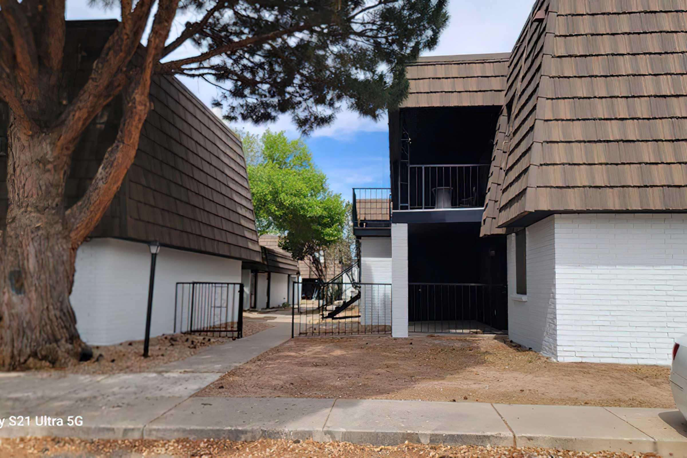 Two multi-story buildings with sloped,