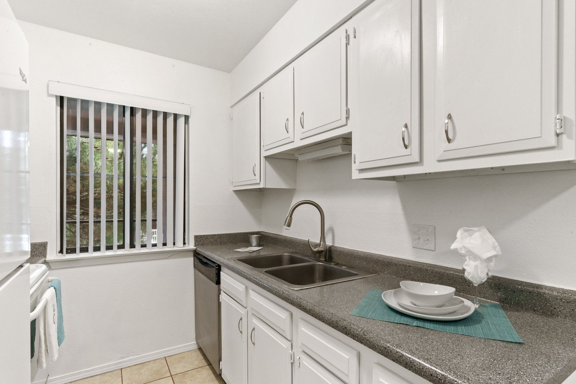 a kitchen with a sink and a window