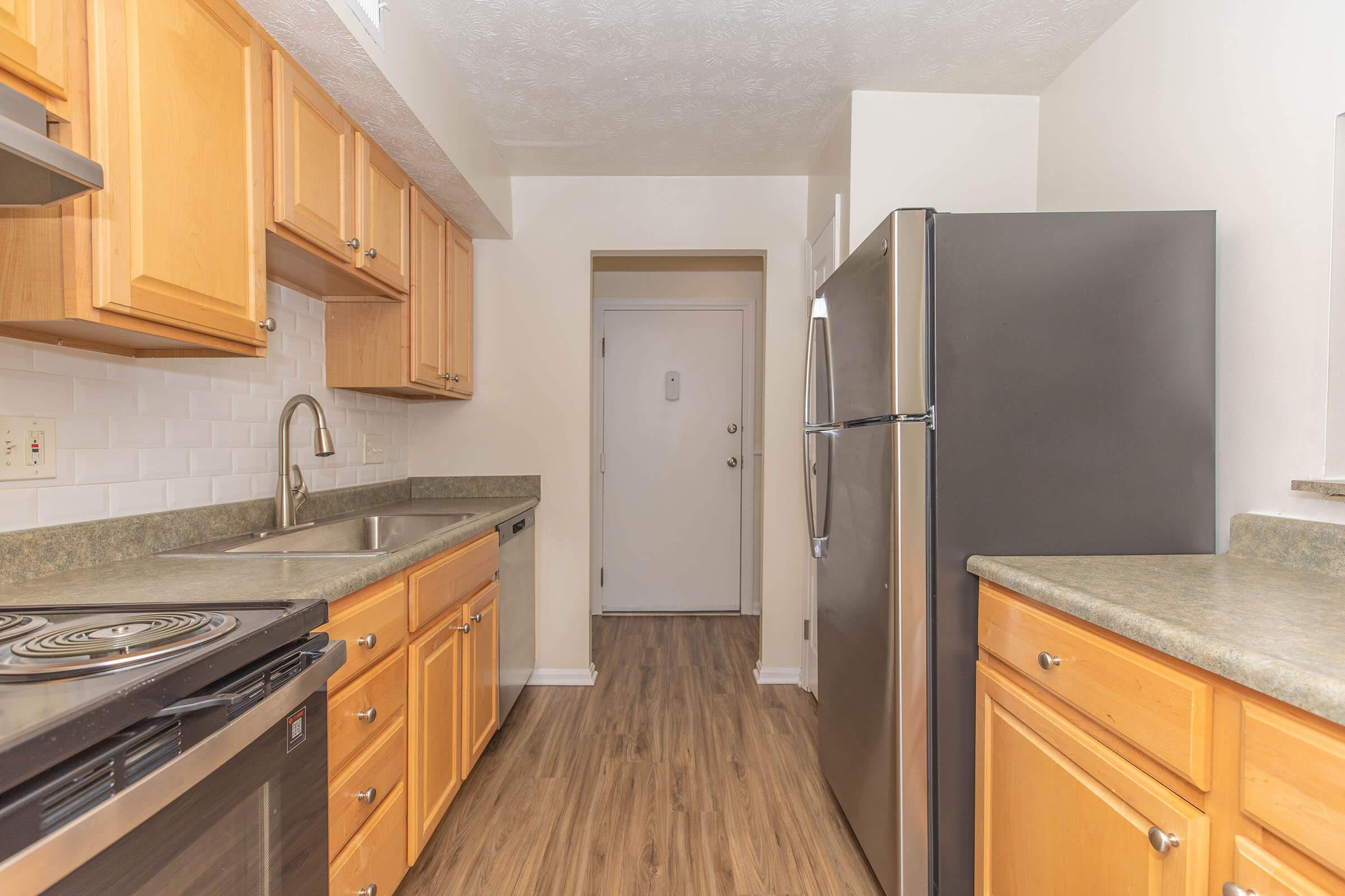 a kitchen with stainless steel appliances and wooden cabinets