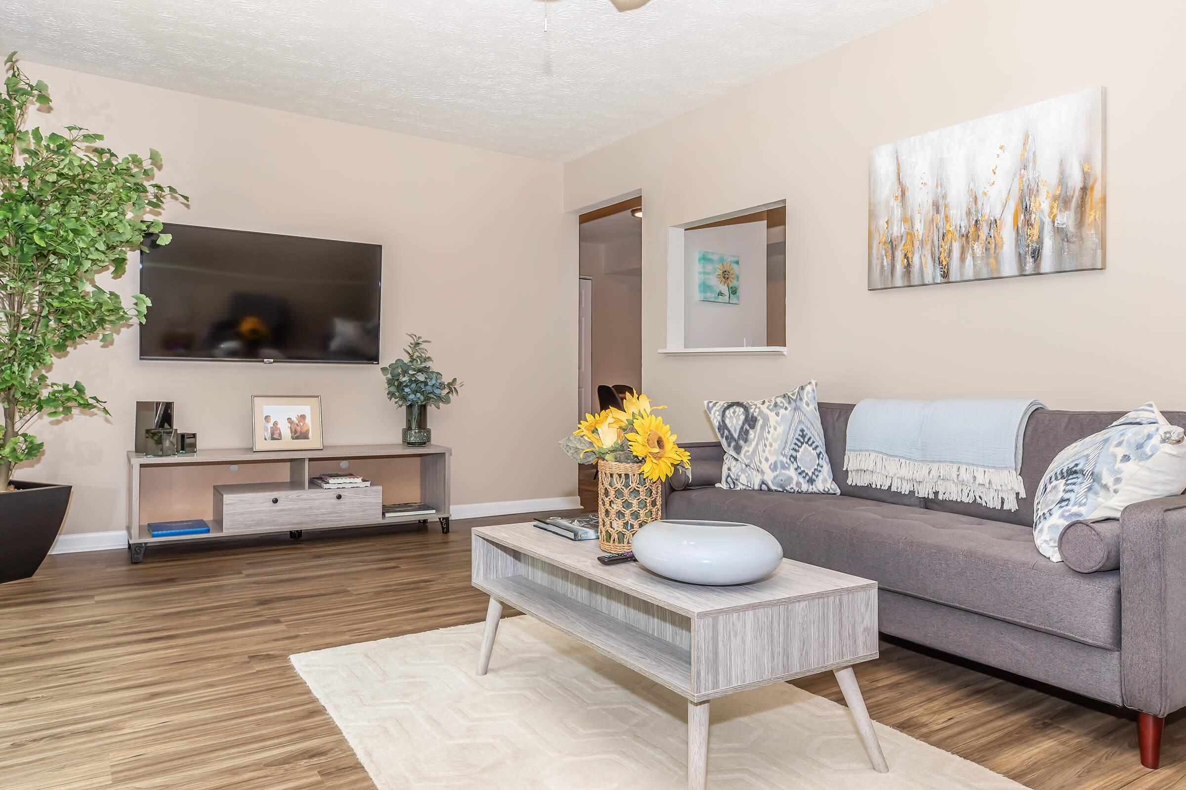 a living room filled with furniture and a flat screen tv