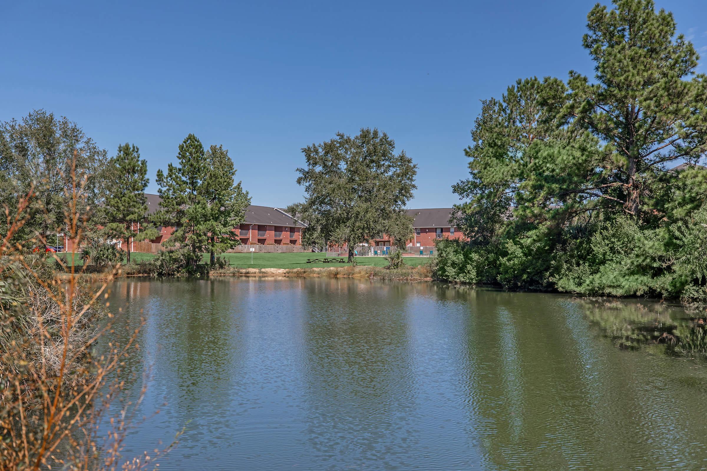 a pond next to a body of water