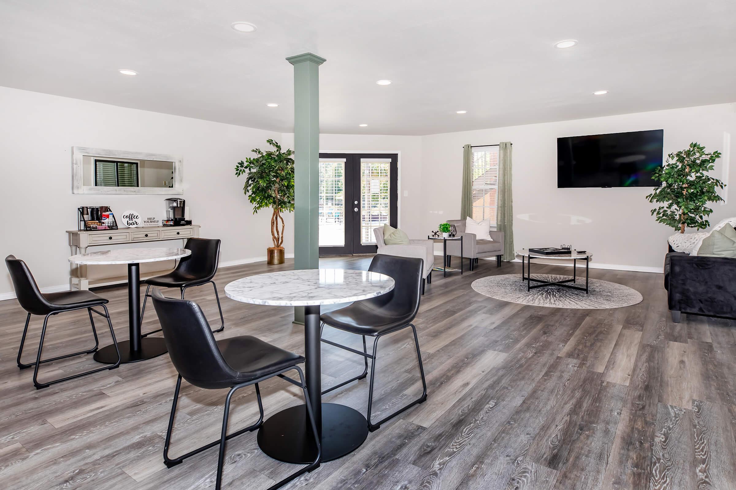 a living room filled with furniture and a flat screen tv