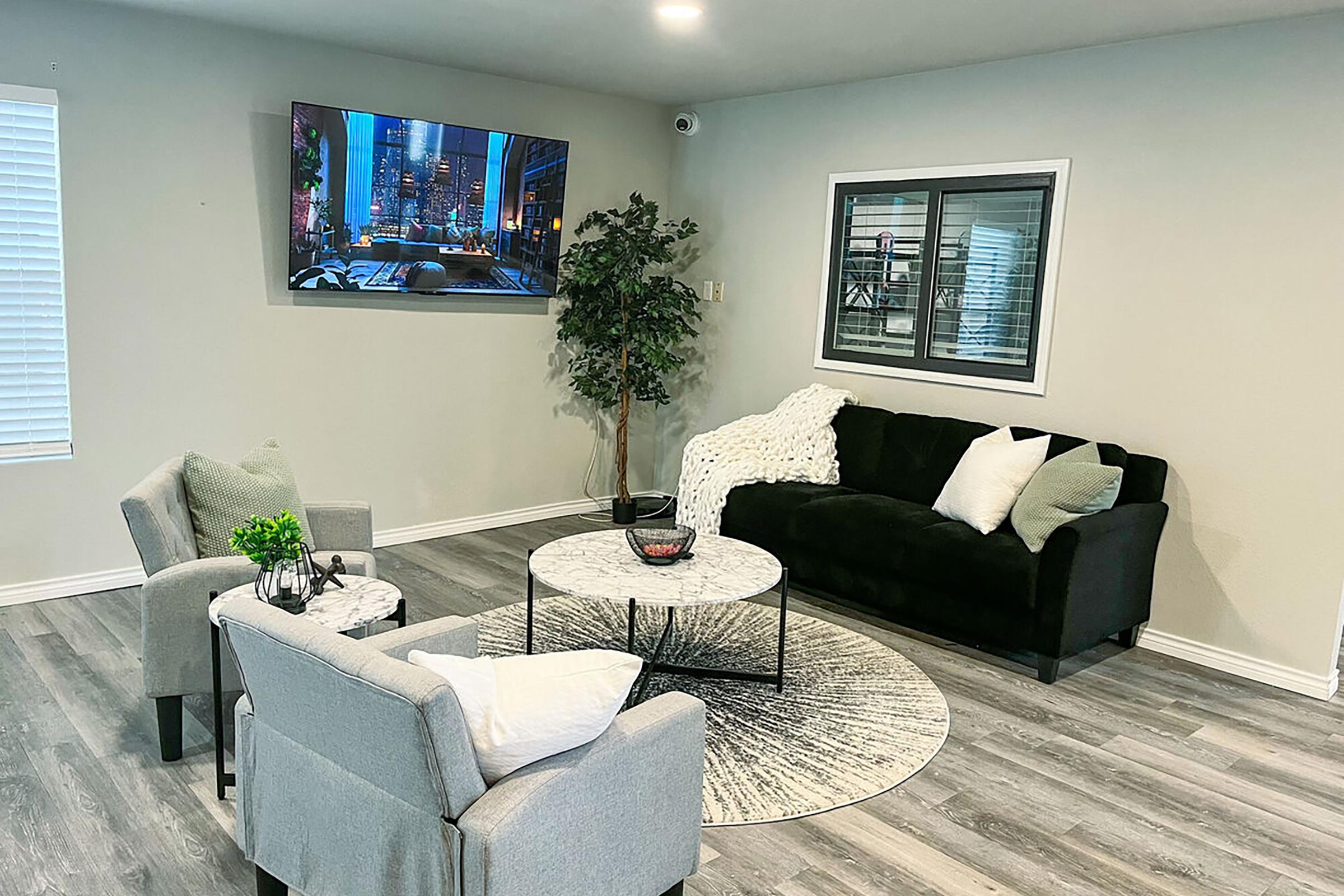 a living room filled with furniture and a flat screen tv