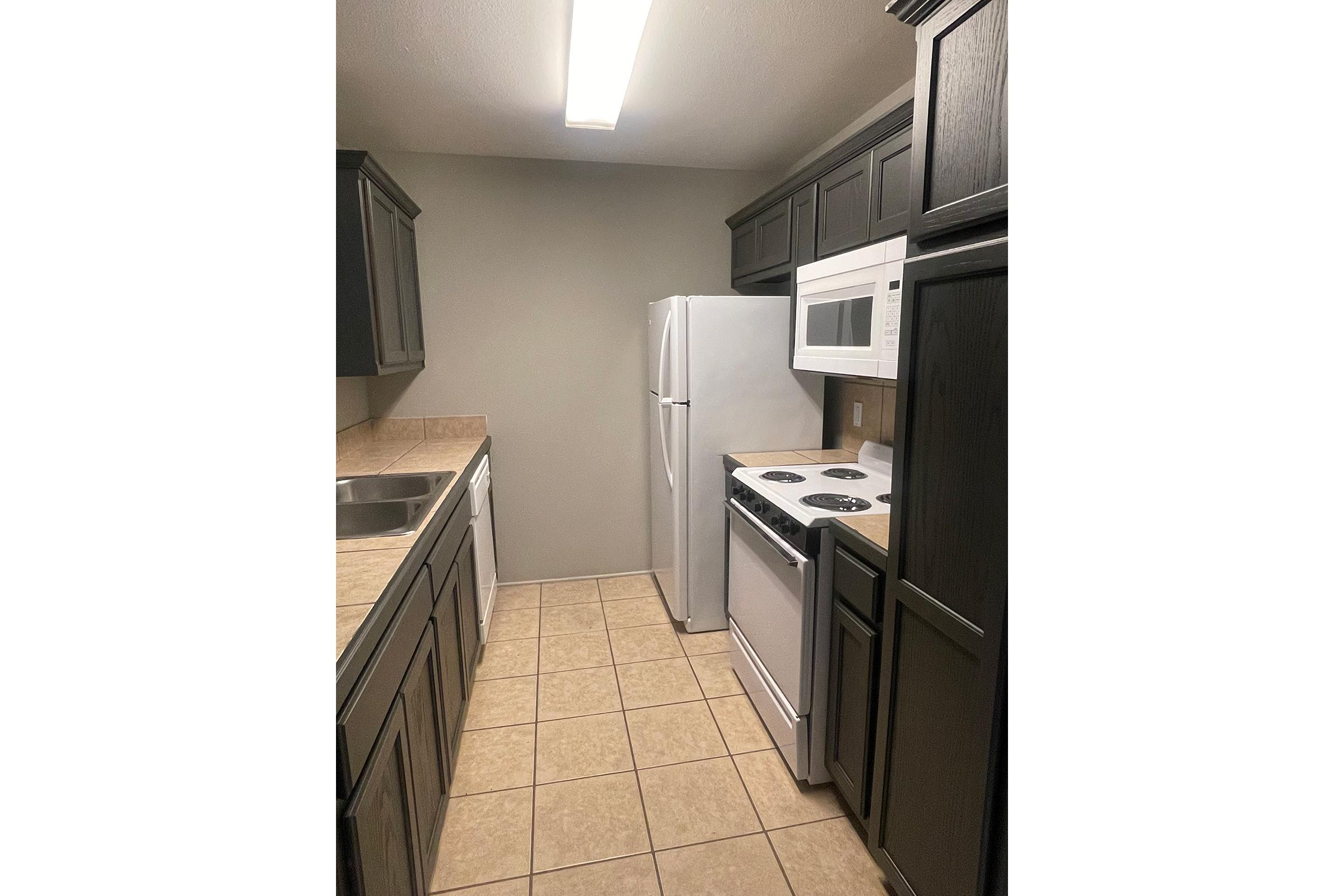 a kitchen with a tile floor