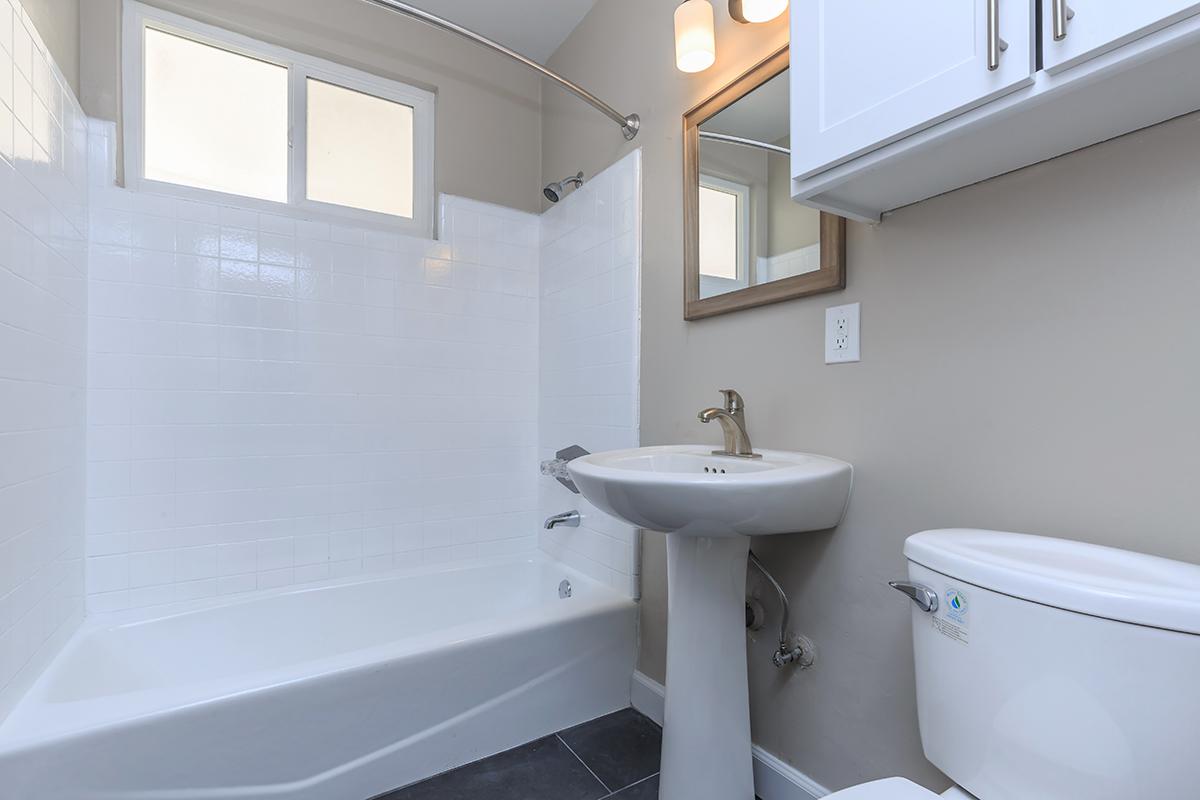 Flats on Elk provides modern bathrooms. We have white surrounds in the tub-shower, extra storage above the commode and good lighting.
