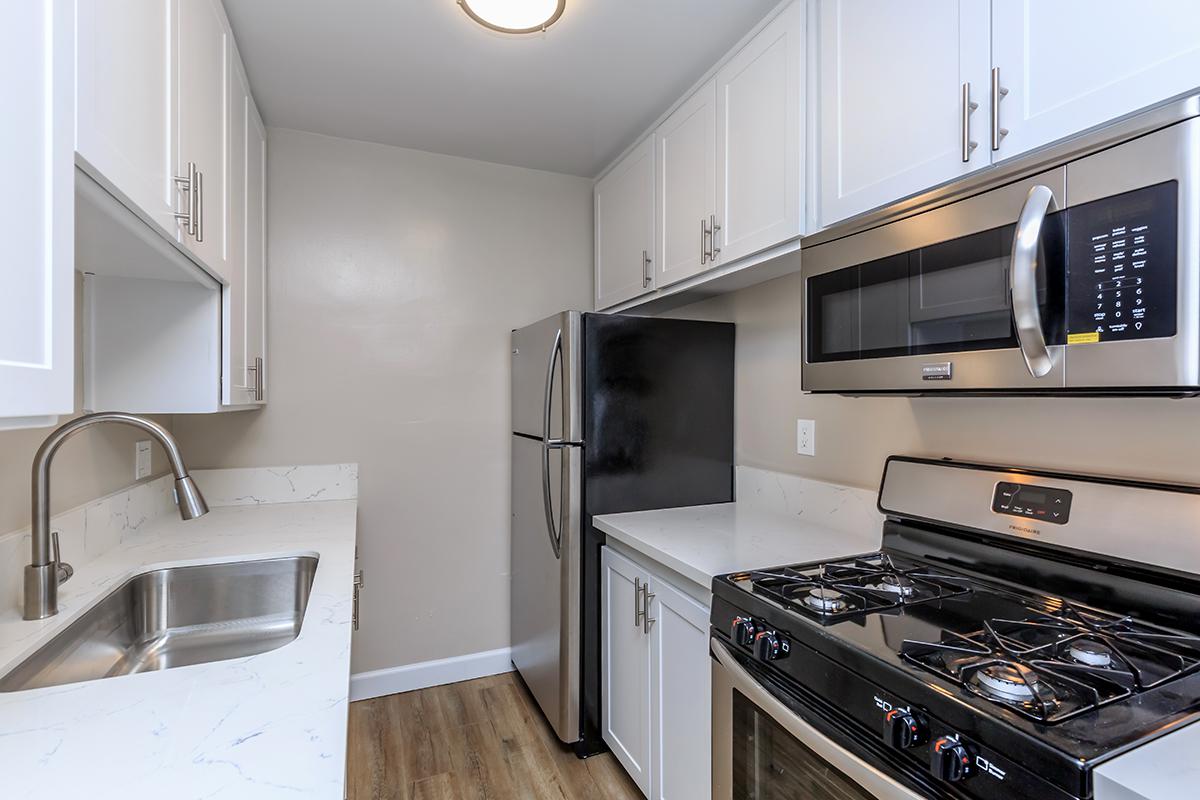 We provide an over the stove microwave in our 1 bedroom 1 bathroom floor plan A at Flats on Elk, along with a goose neck faucet.
