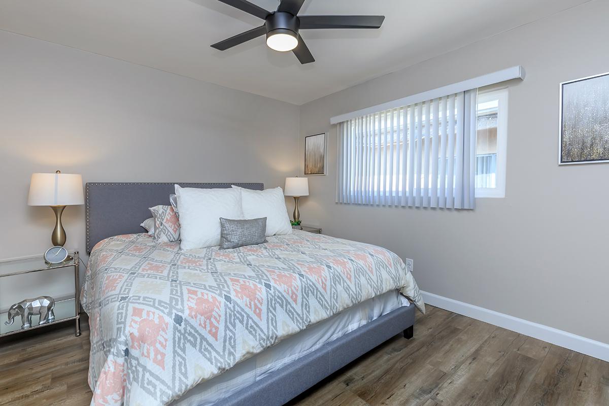 Our one bed one bath B floor  plan provides a ceiling fan in the bedroom also a ceiling fan and vertical blinds on the window.