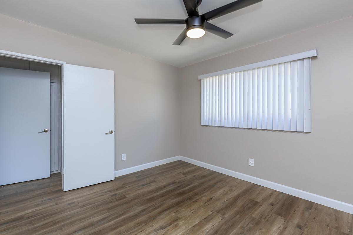 Ceiling fan, vertical blinds and wood-like flooring in our one bed one bath C layout