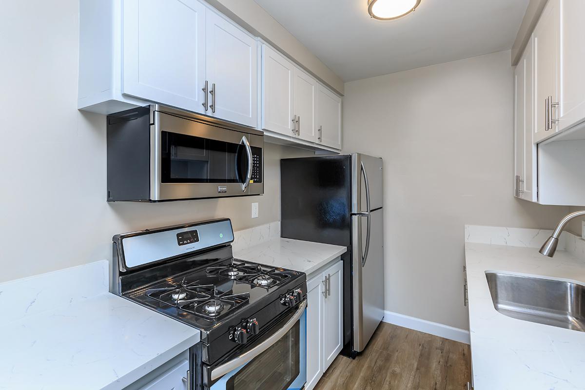Great kitchen showing the stove, overhead microwave and refrigerator here at Flats on Elk