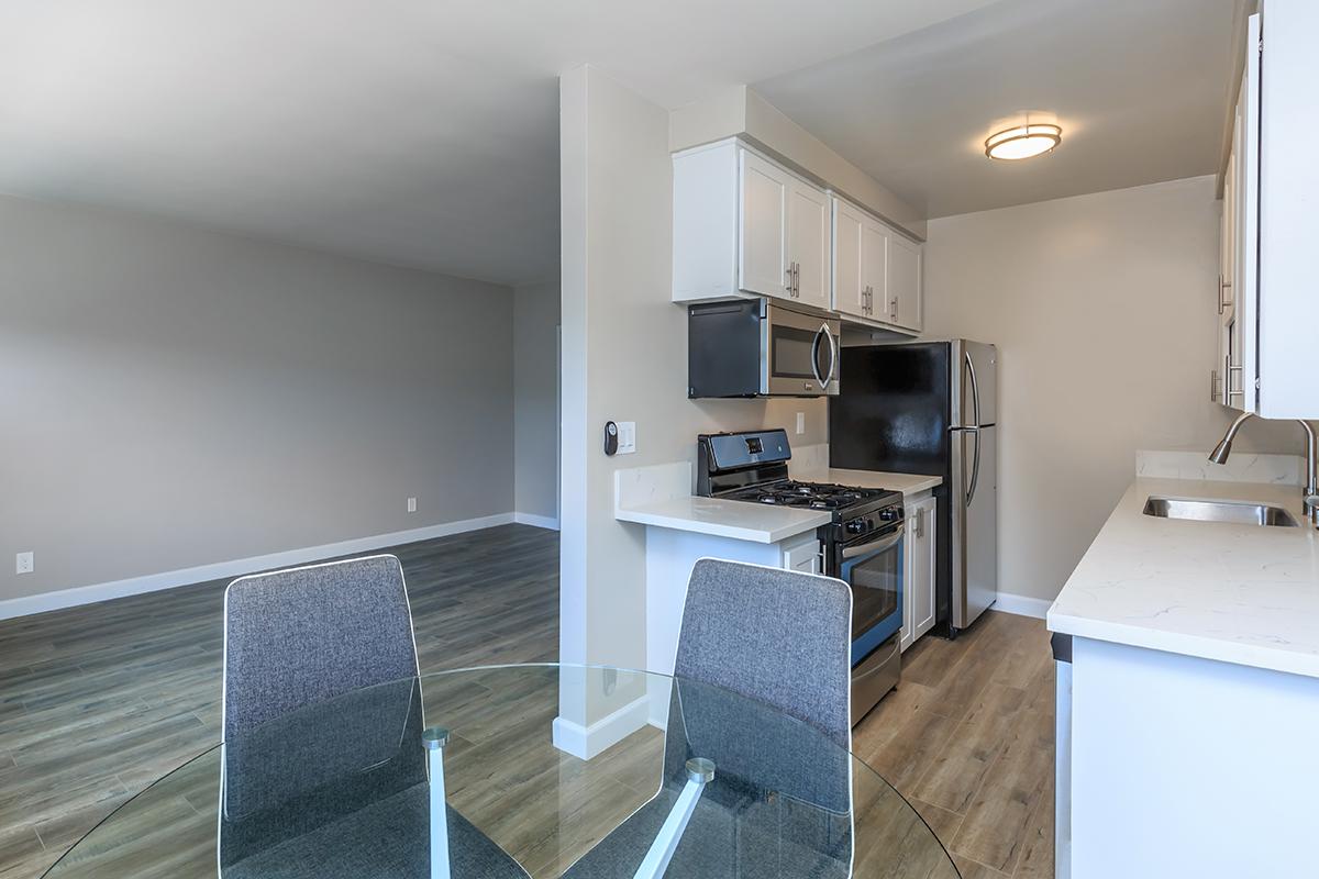 Stainless appliances here at Flats on Elk that showcase the over the stove microwave and wood-like floors.