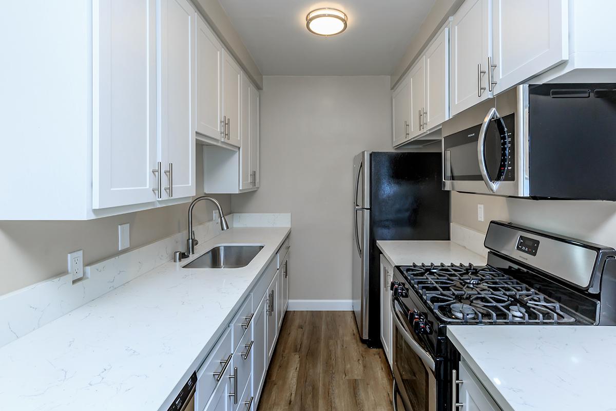 Great stainless appliances look so good next to the white cabinets and countertops here in our one bed one bath D floor plan at Flats on Elk