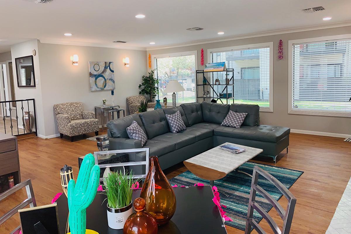 a living room filled with furniture and a large window