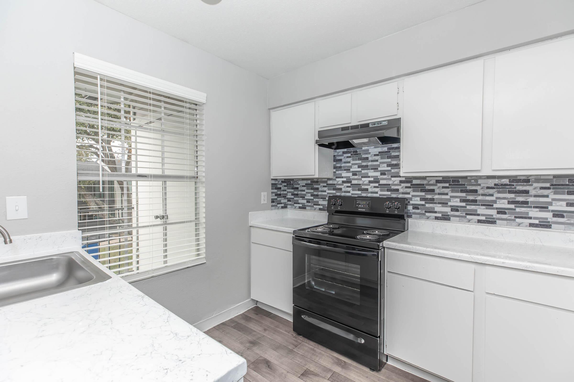 a kitchen with a sink and a window