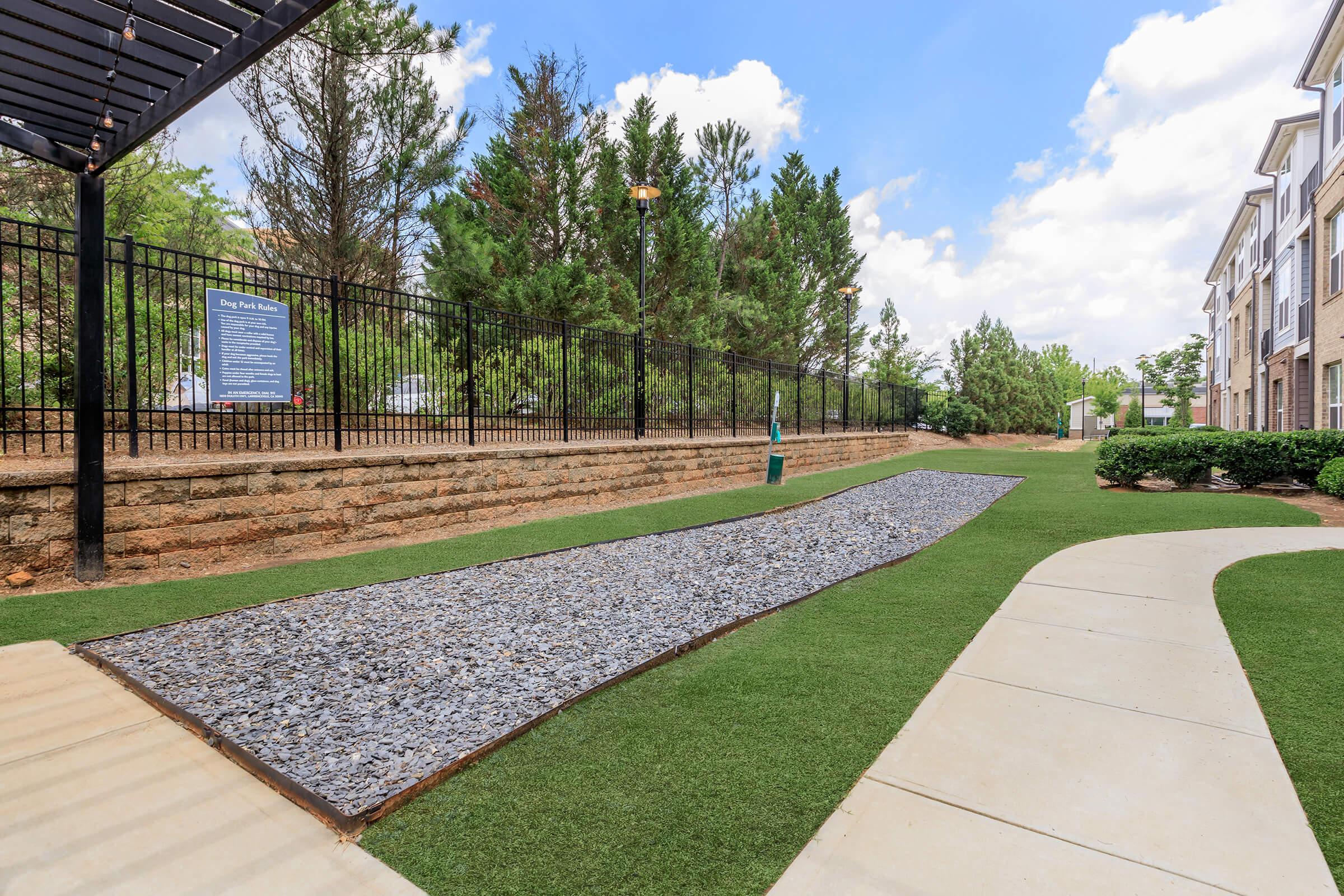 a path with trees on the side of a building