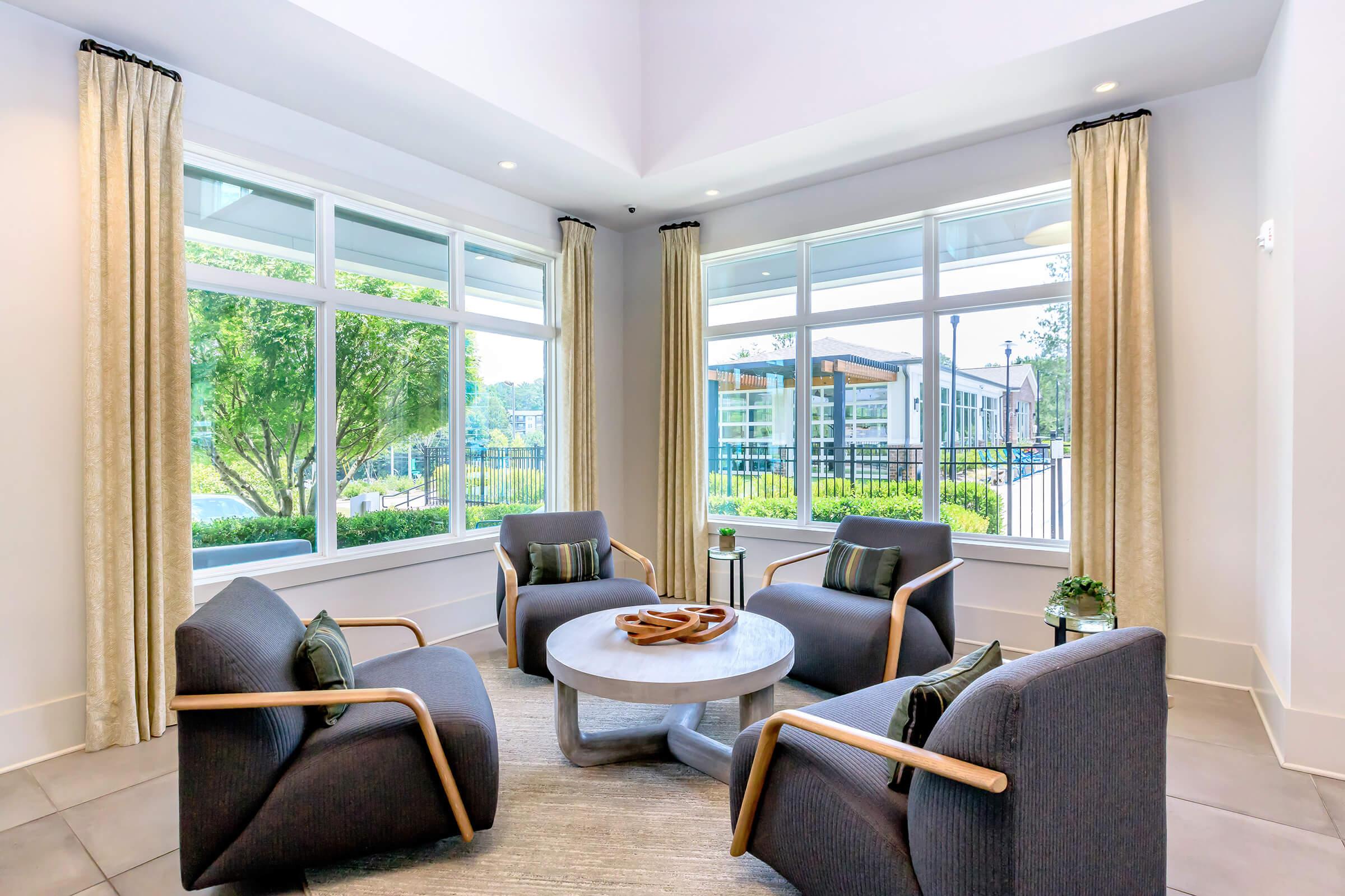 a living room filled with furniture and a large window