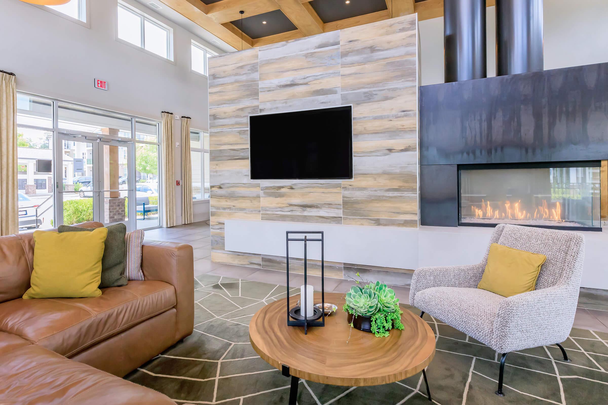 a living room filled with furniture and a large window