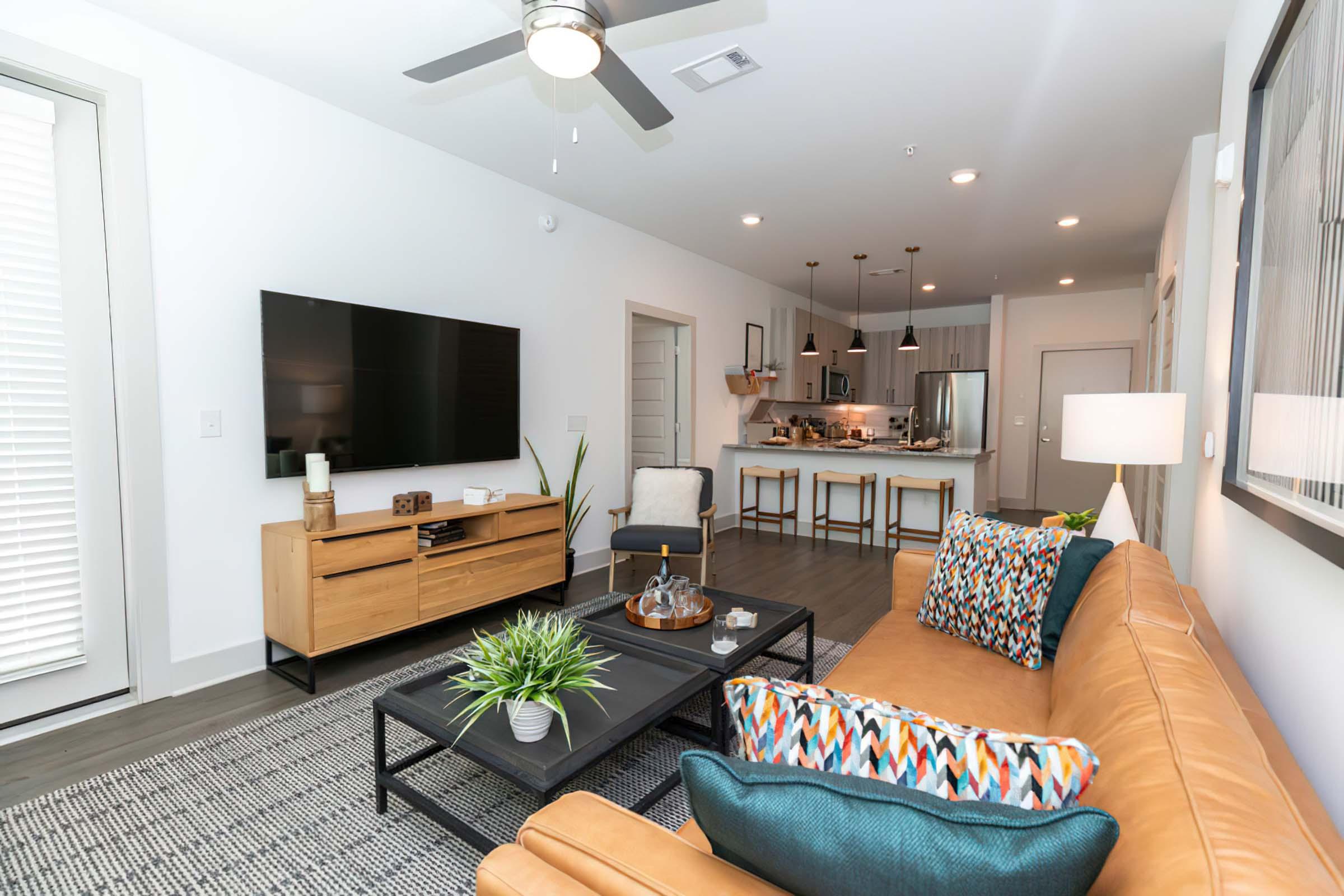 a living room filled with furniture and a flat screen tv