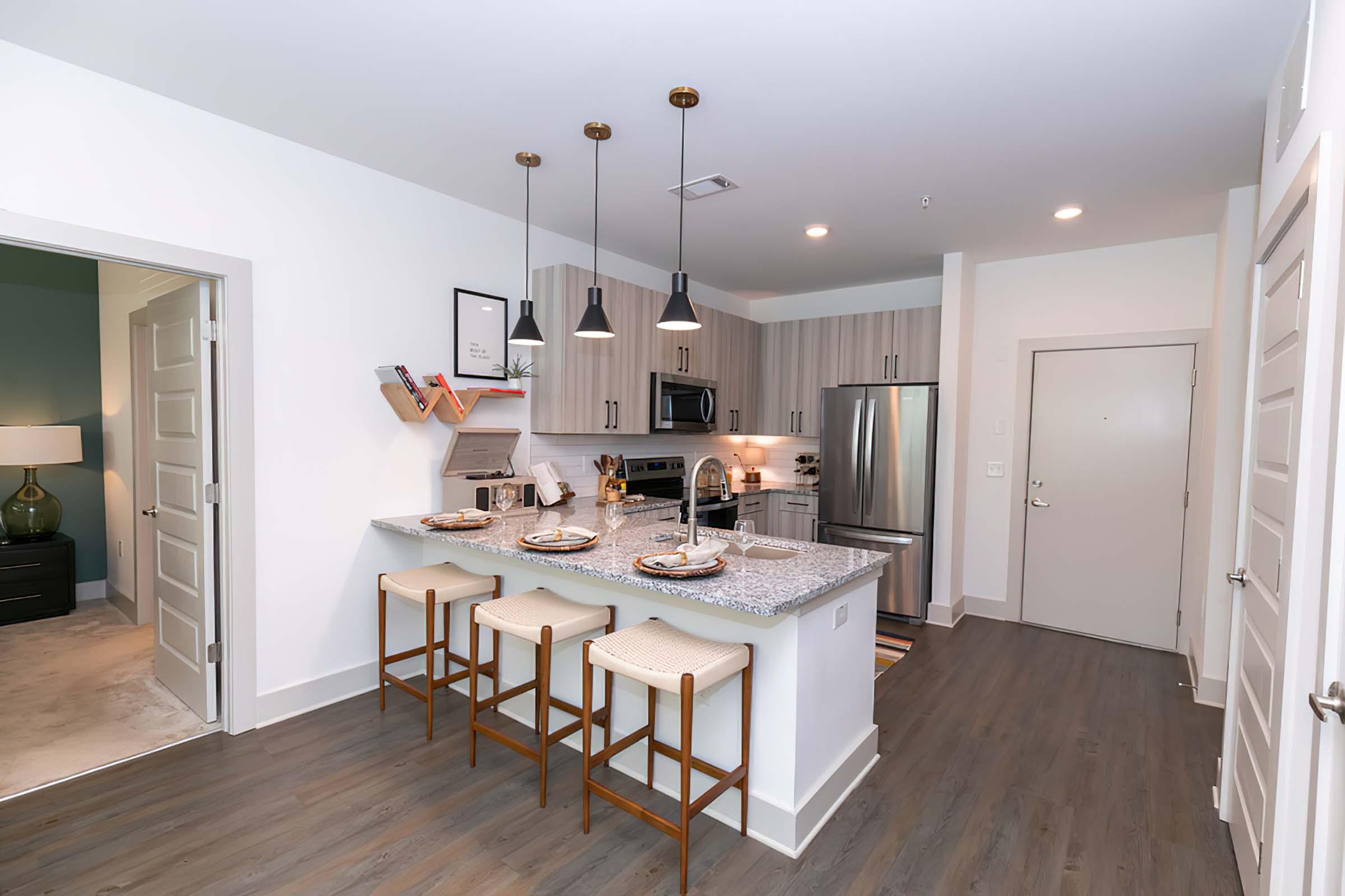 a kitchen with a wood floor in a room