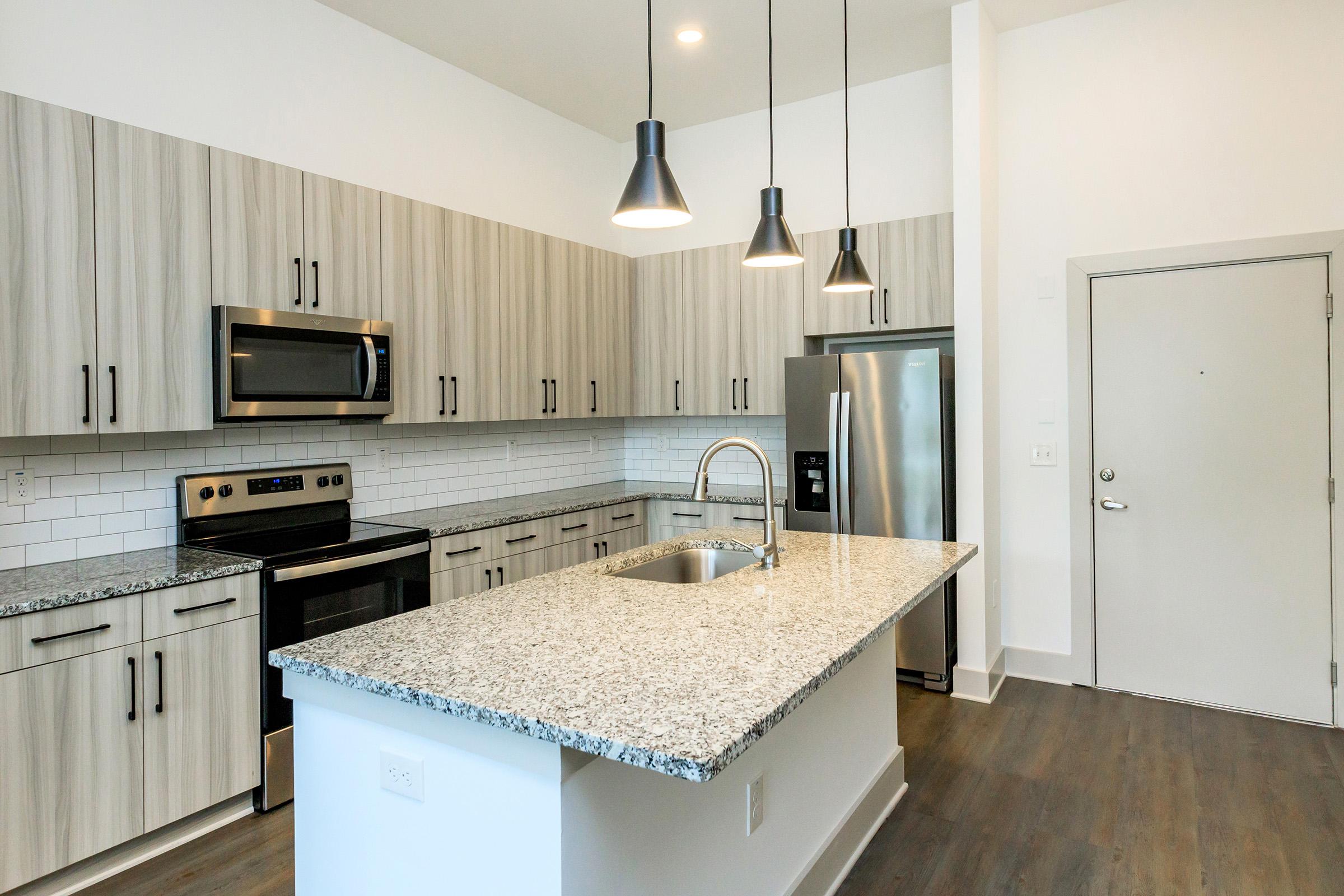 a kitchen with a sink and a mirror