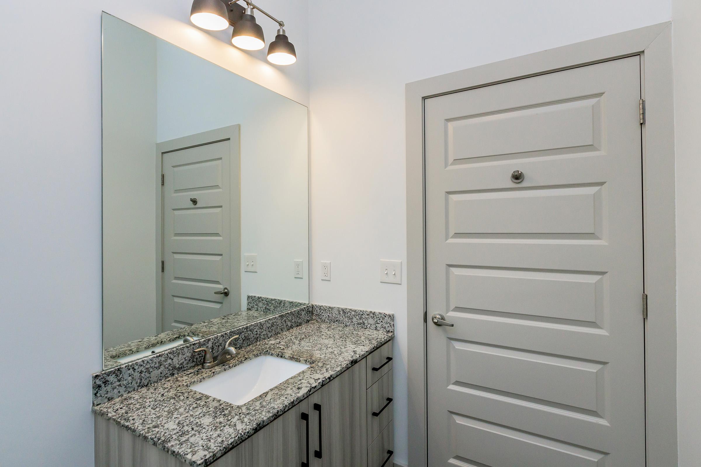 a kitchen with a sink and a mirror