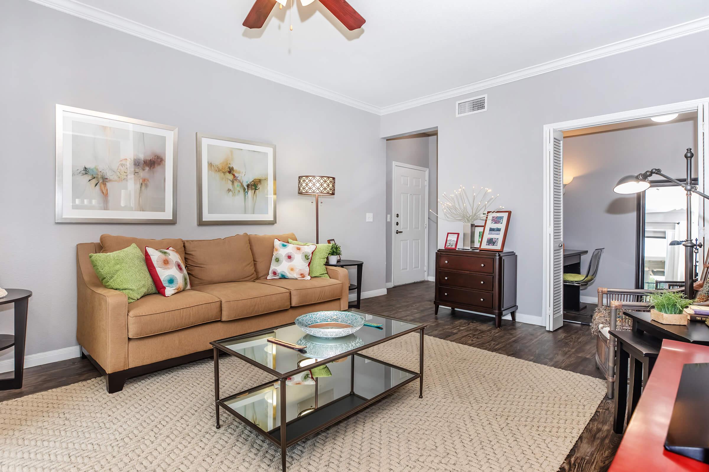 a living room filled with furniture and a flat screen tv