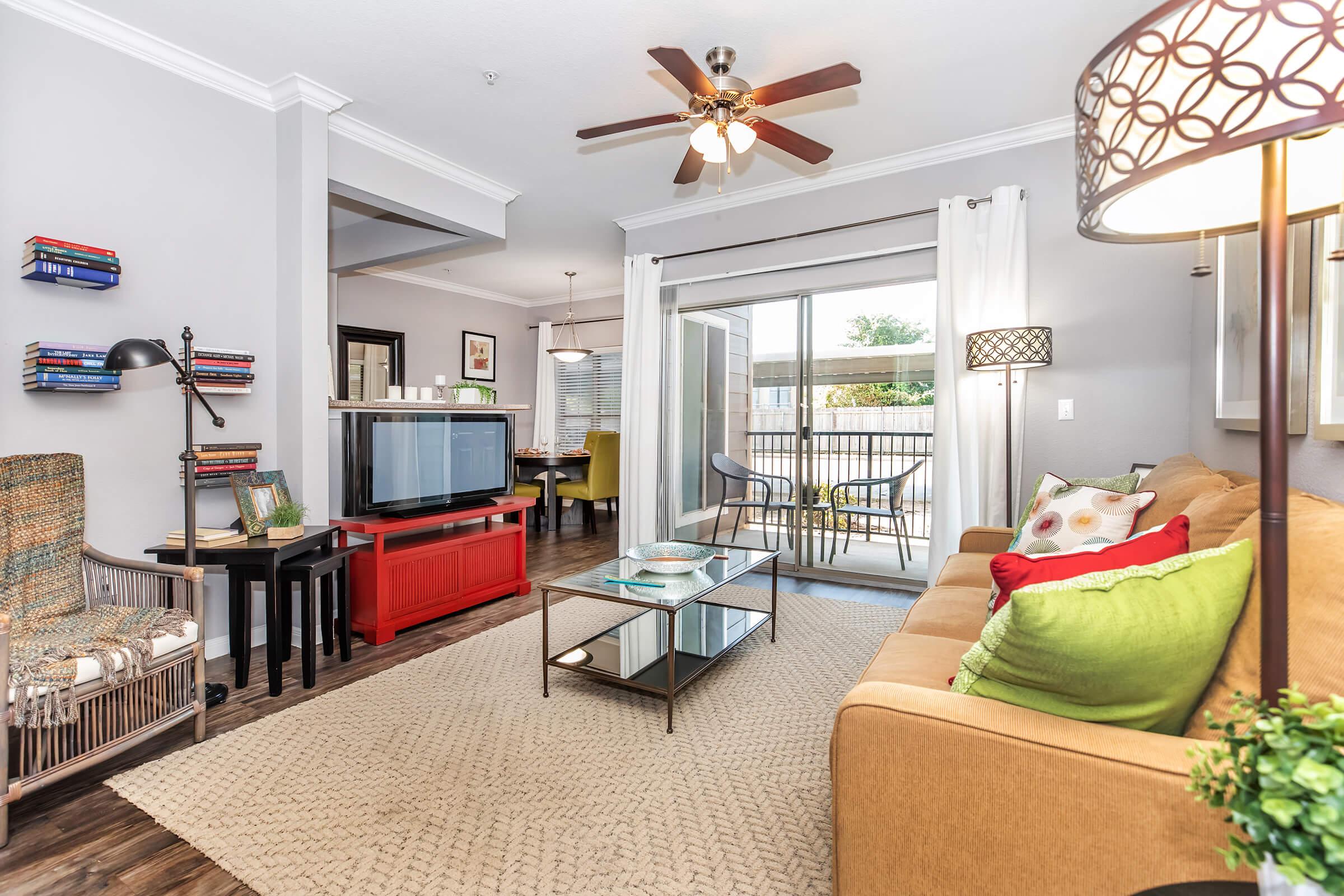 a living room filled with furniture and a large window