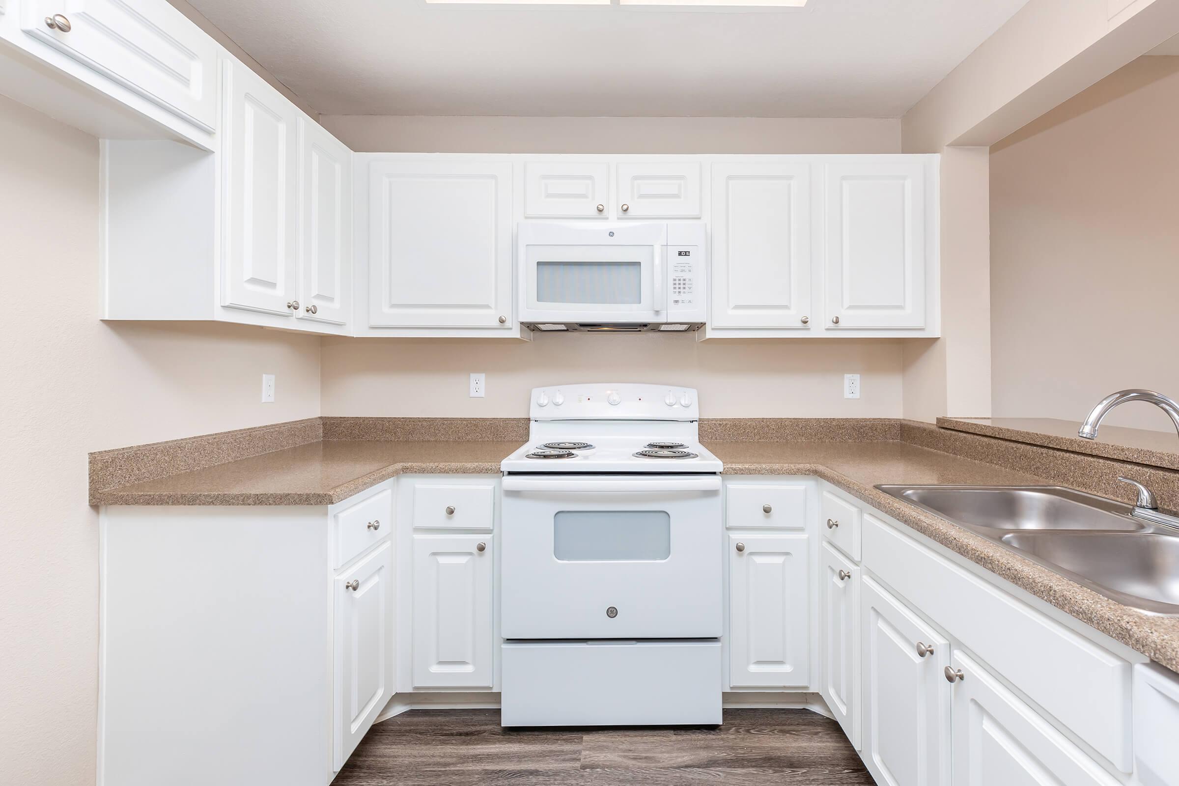 a kitchen with a stove and a refrigerator