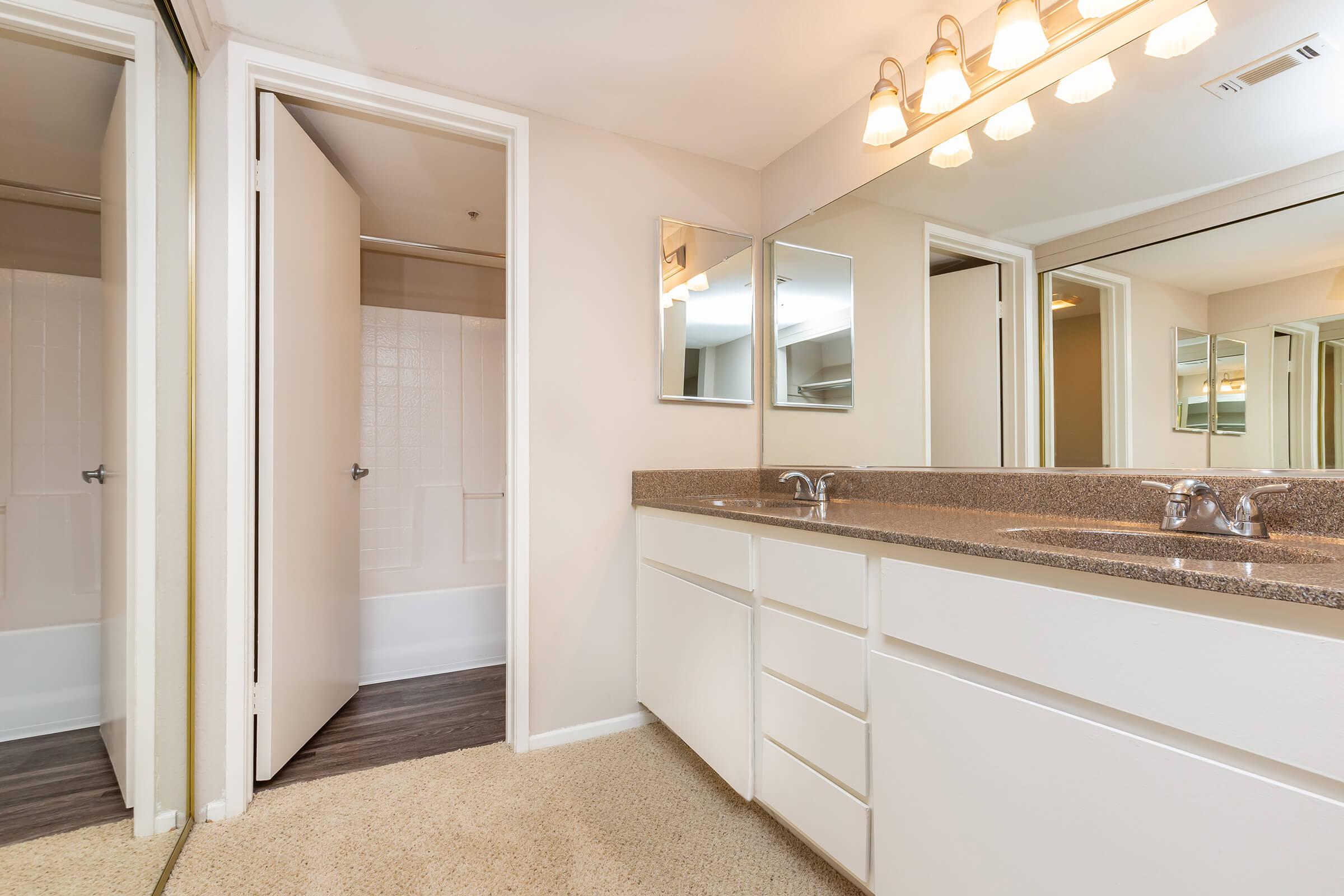 a kitchen with a sink and a mirror