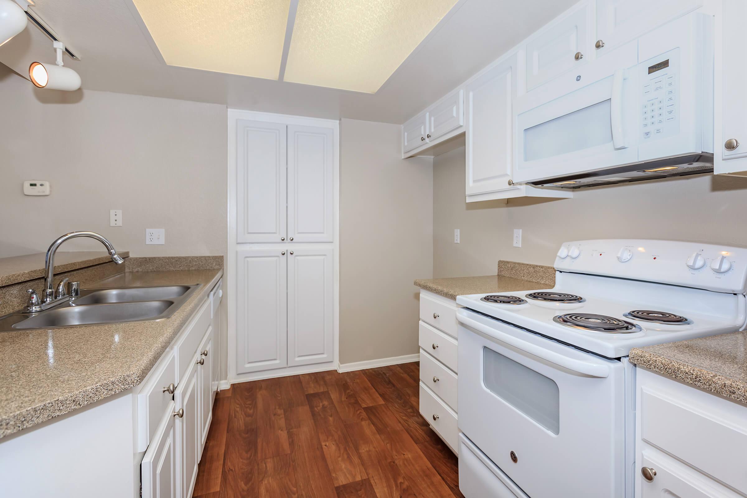 a kitchen with a stove and a sink