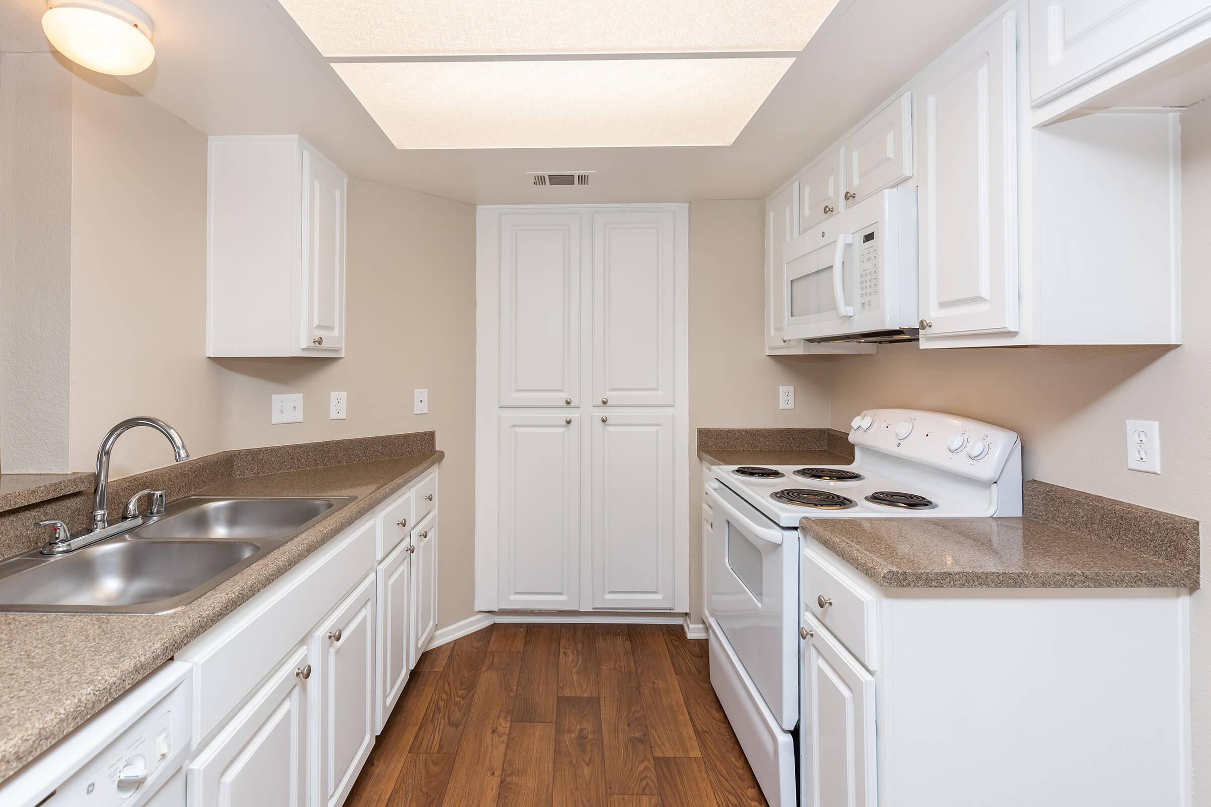 a kitchen with a sink and a microwave