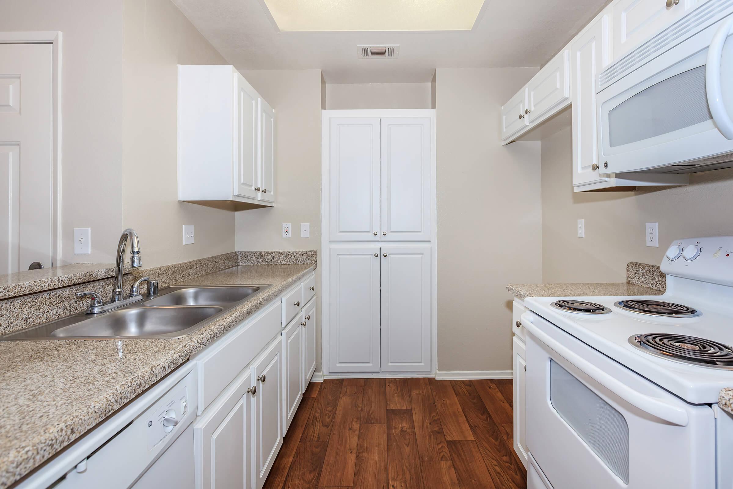 a kitchen with a stove a sink and a microwave