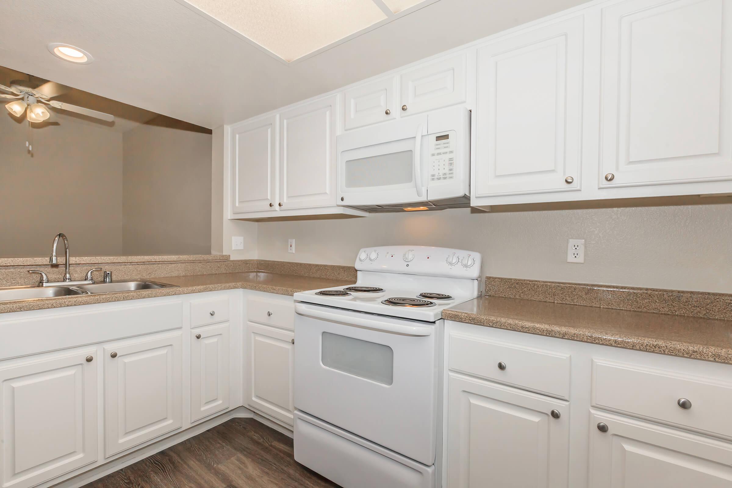 a kitchen with a sink and a microwave