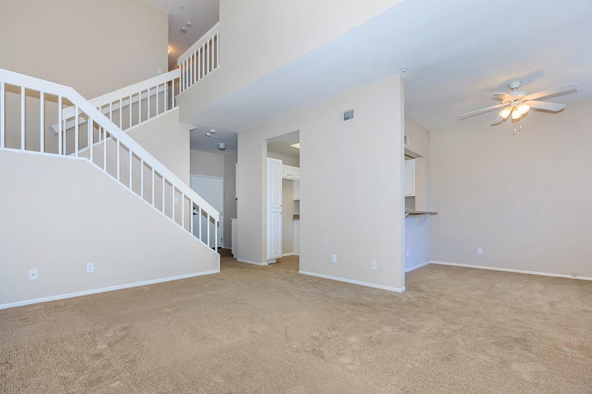 Carpeted living room with stairs