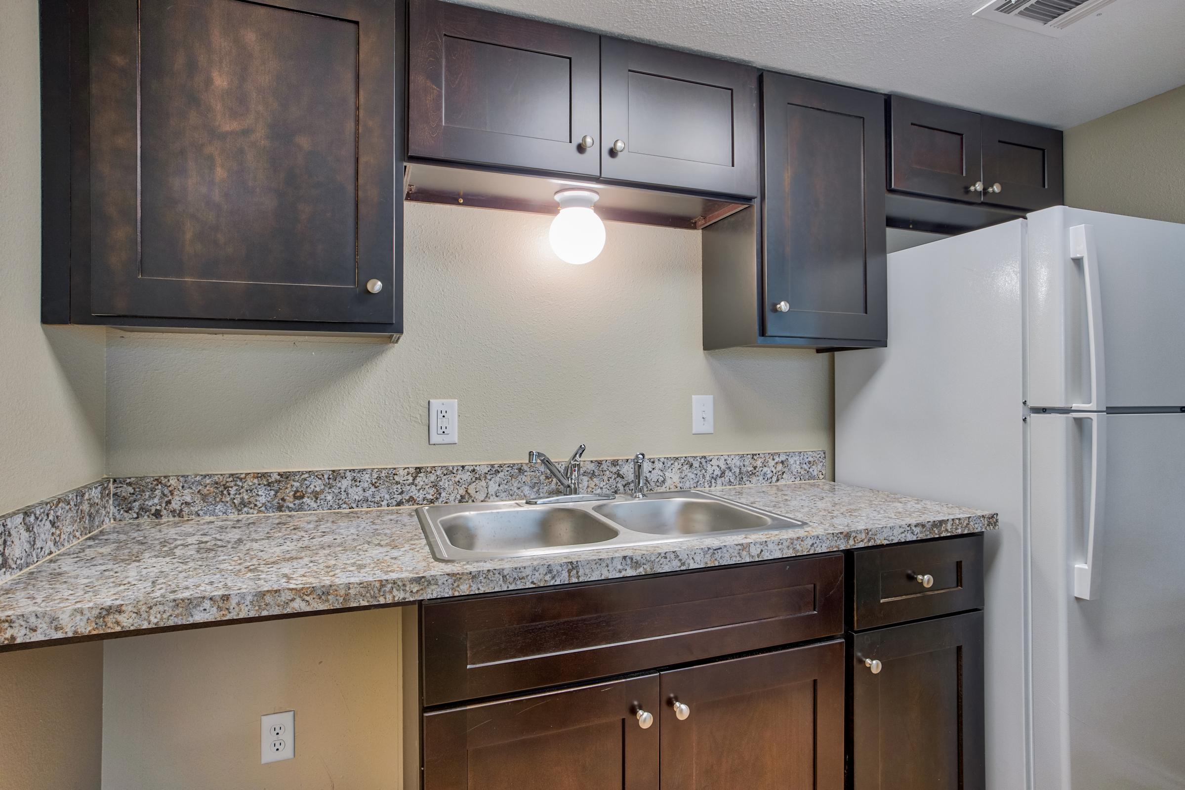 a kitchen with a stove sink and refrigerator