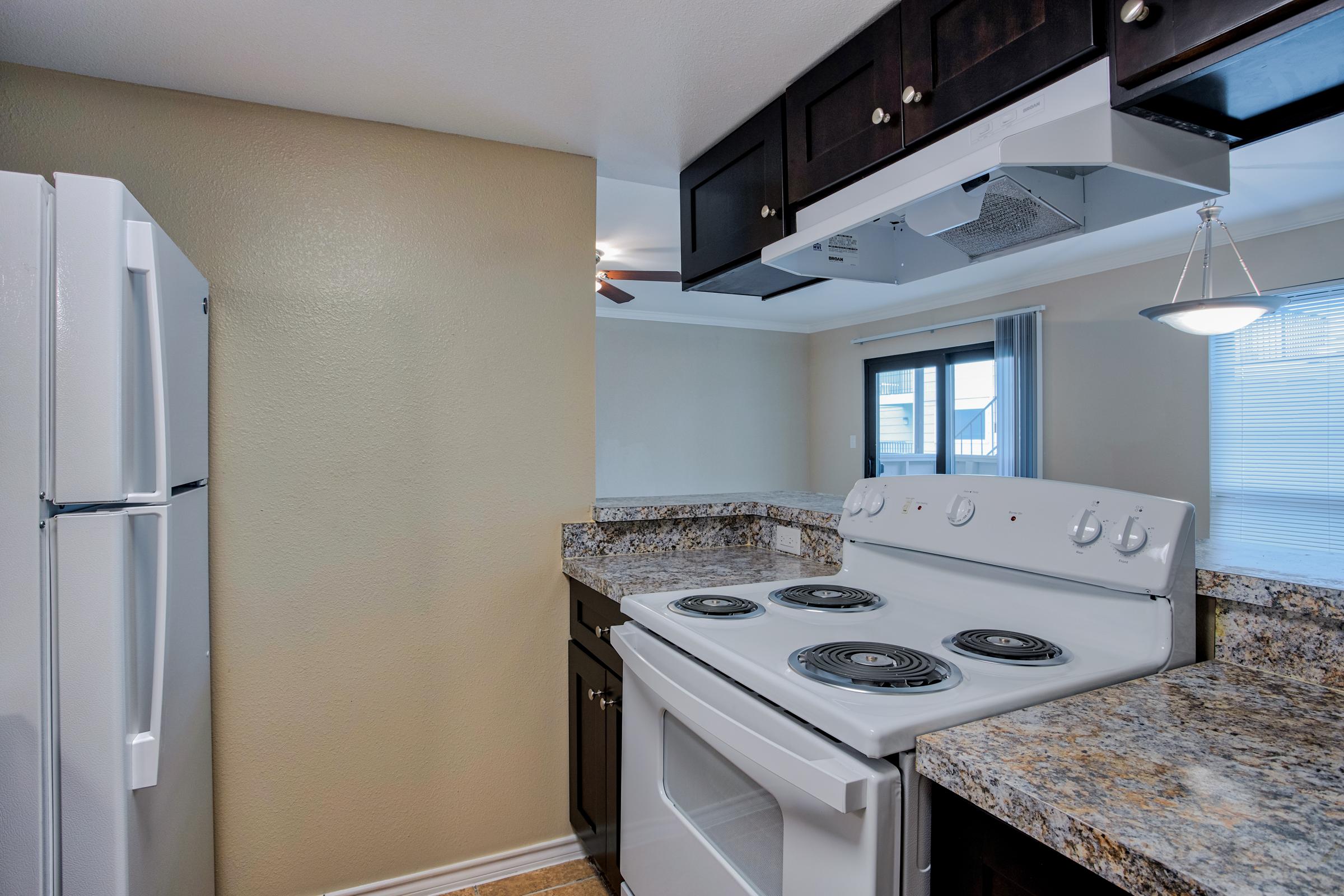 a stove top oven sitting inside of a kitchen