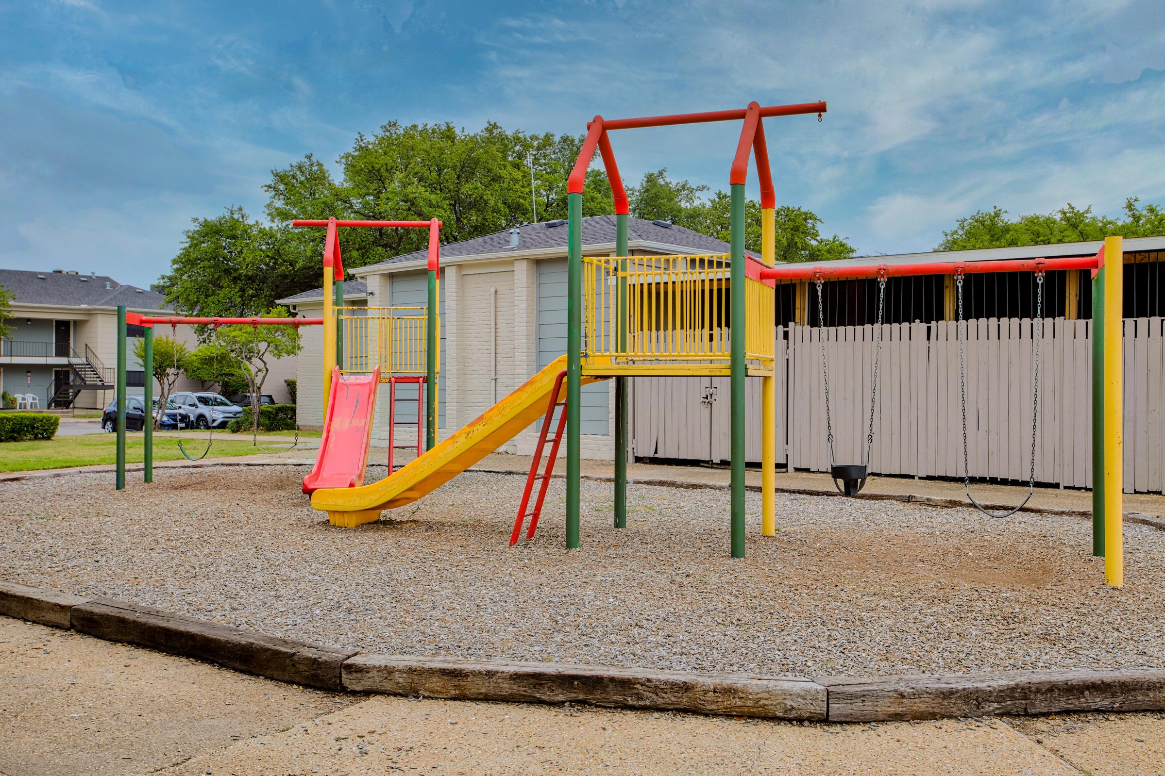 a playground in front of a fence