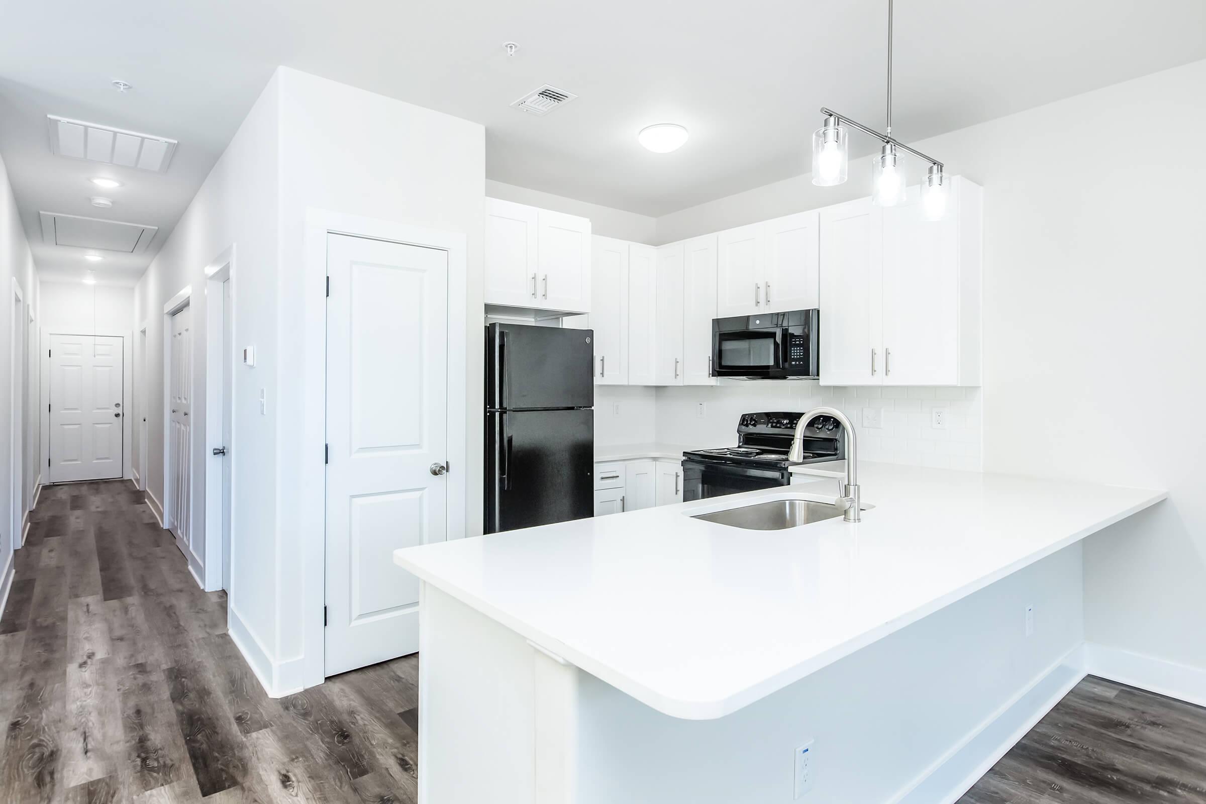 a kitchen with a sink and a mirror