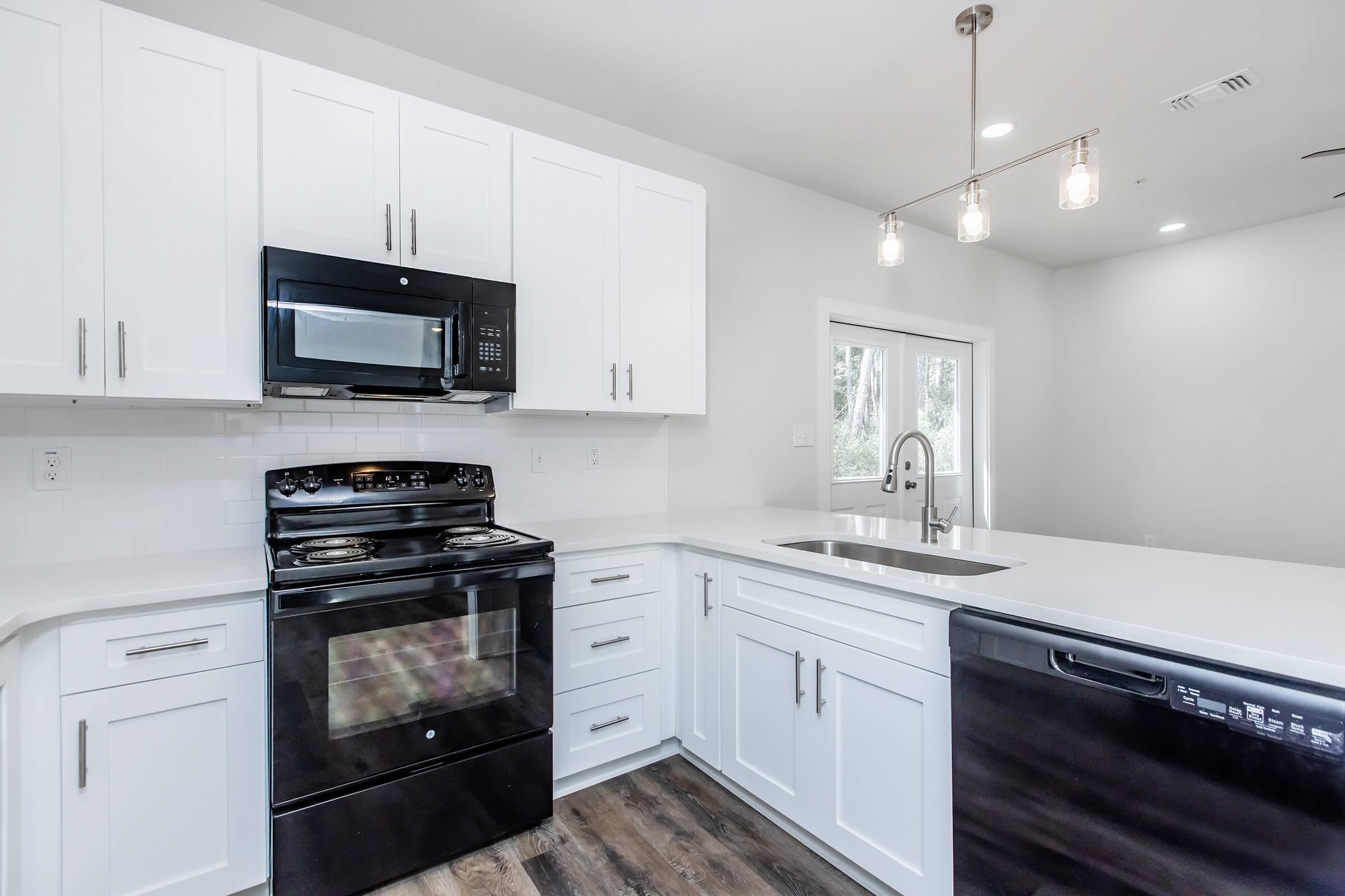 a stove top oven sitting inside of a kitchen