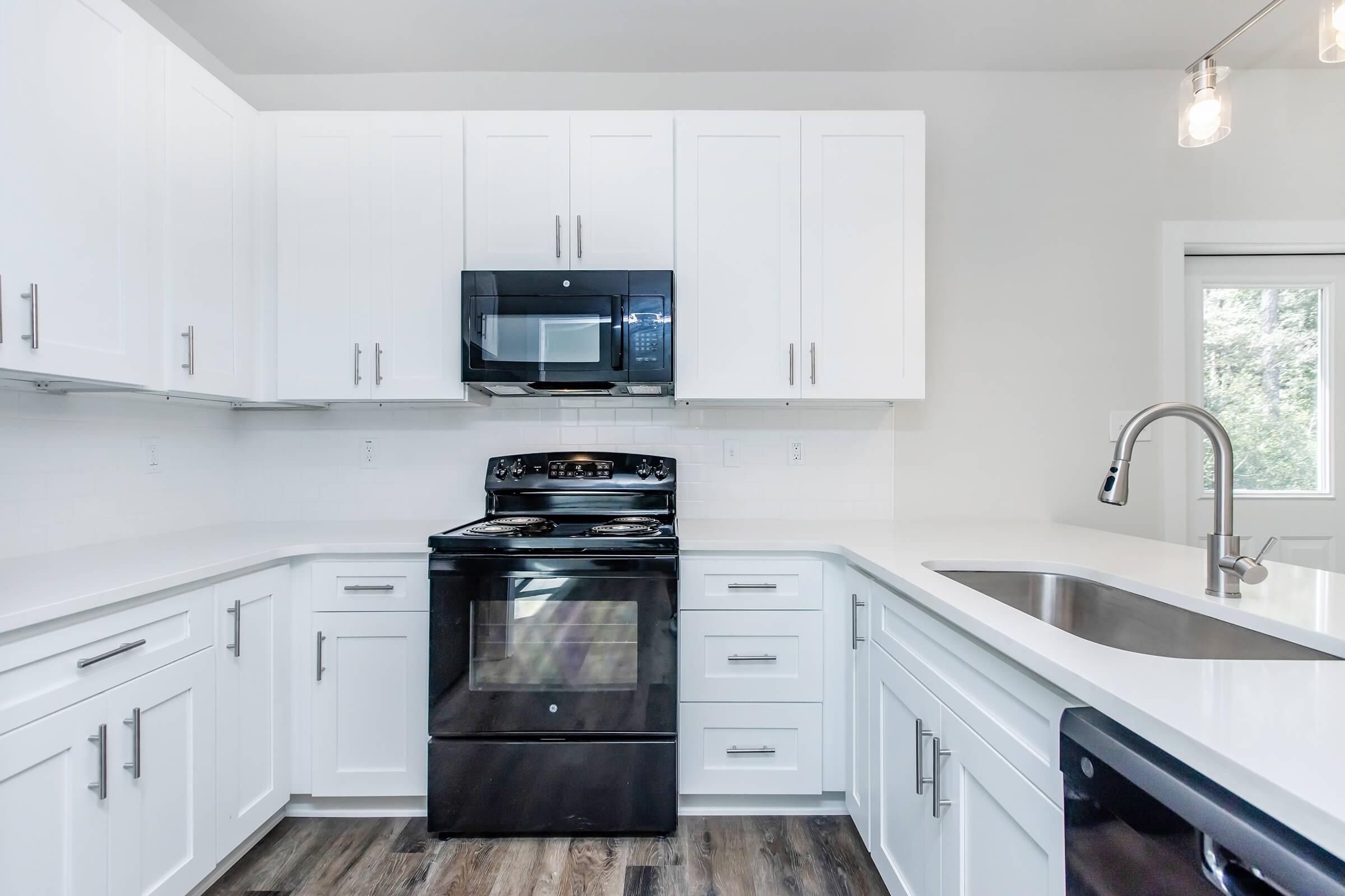 a kitchen with a sink and a microwave