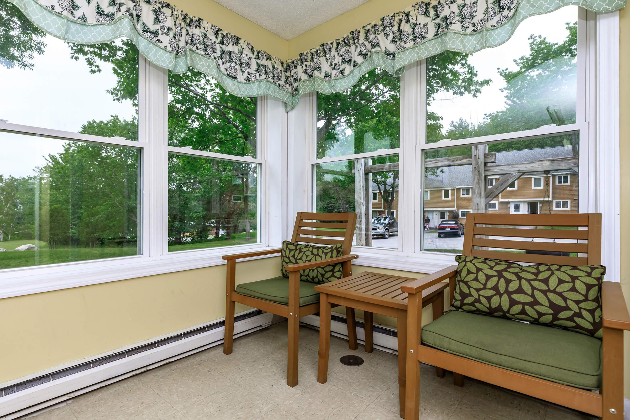 a dining room table in front of a window