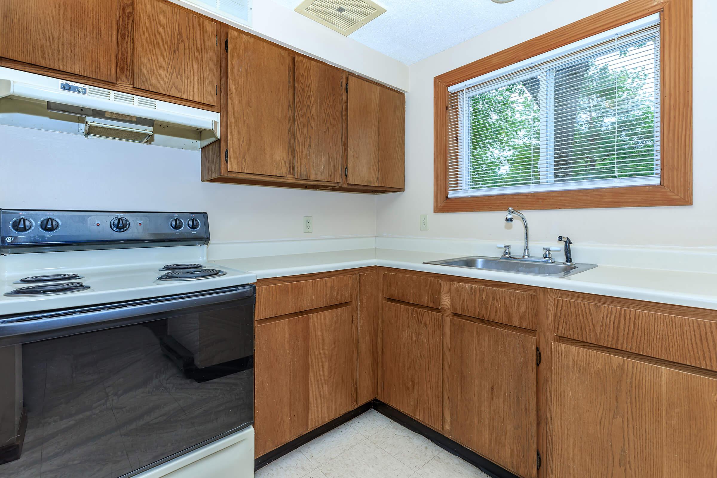 a kitchen with wooden cabinets