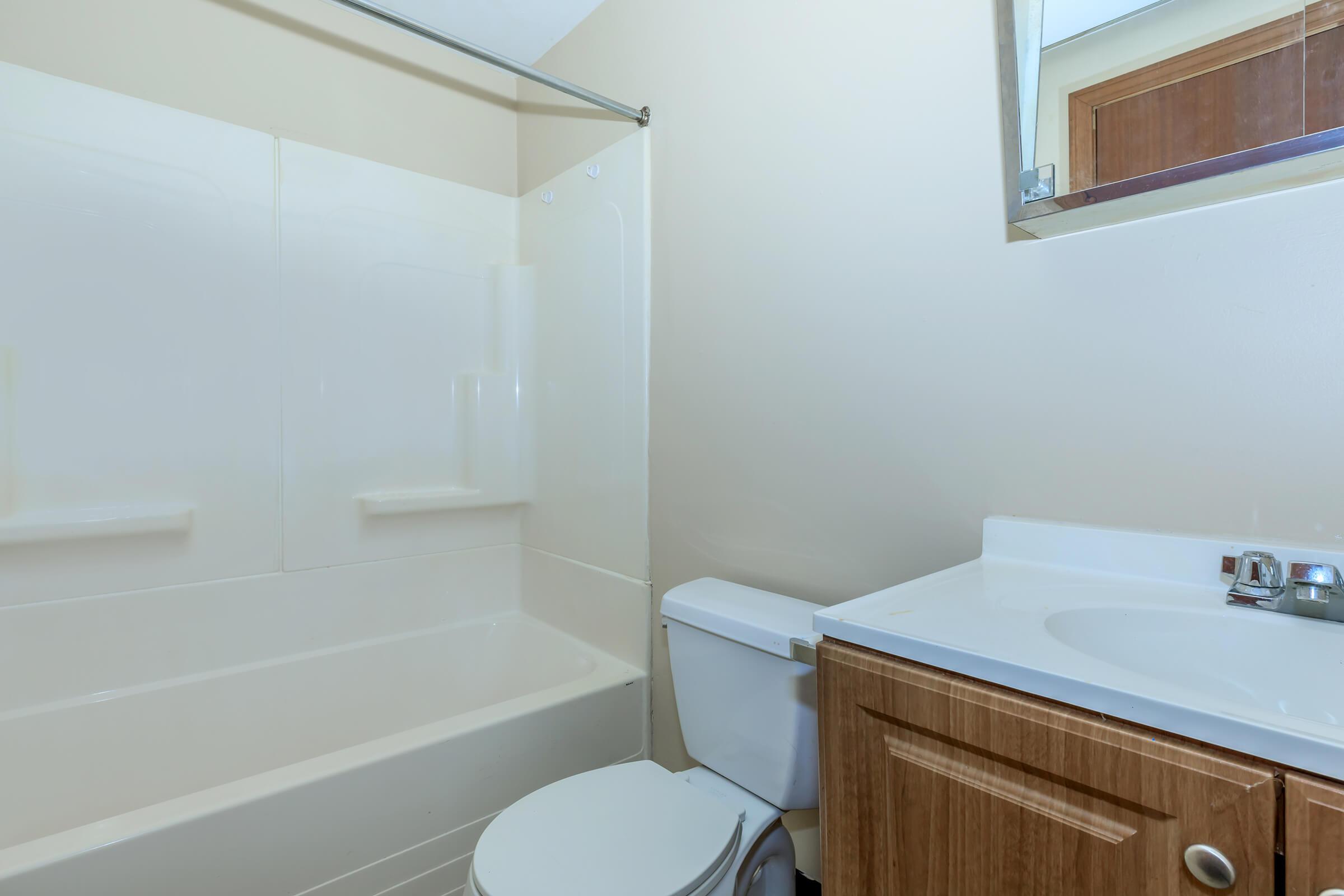 a white tub sitting next to a sink