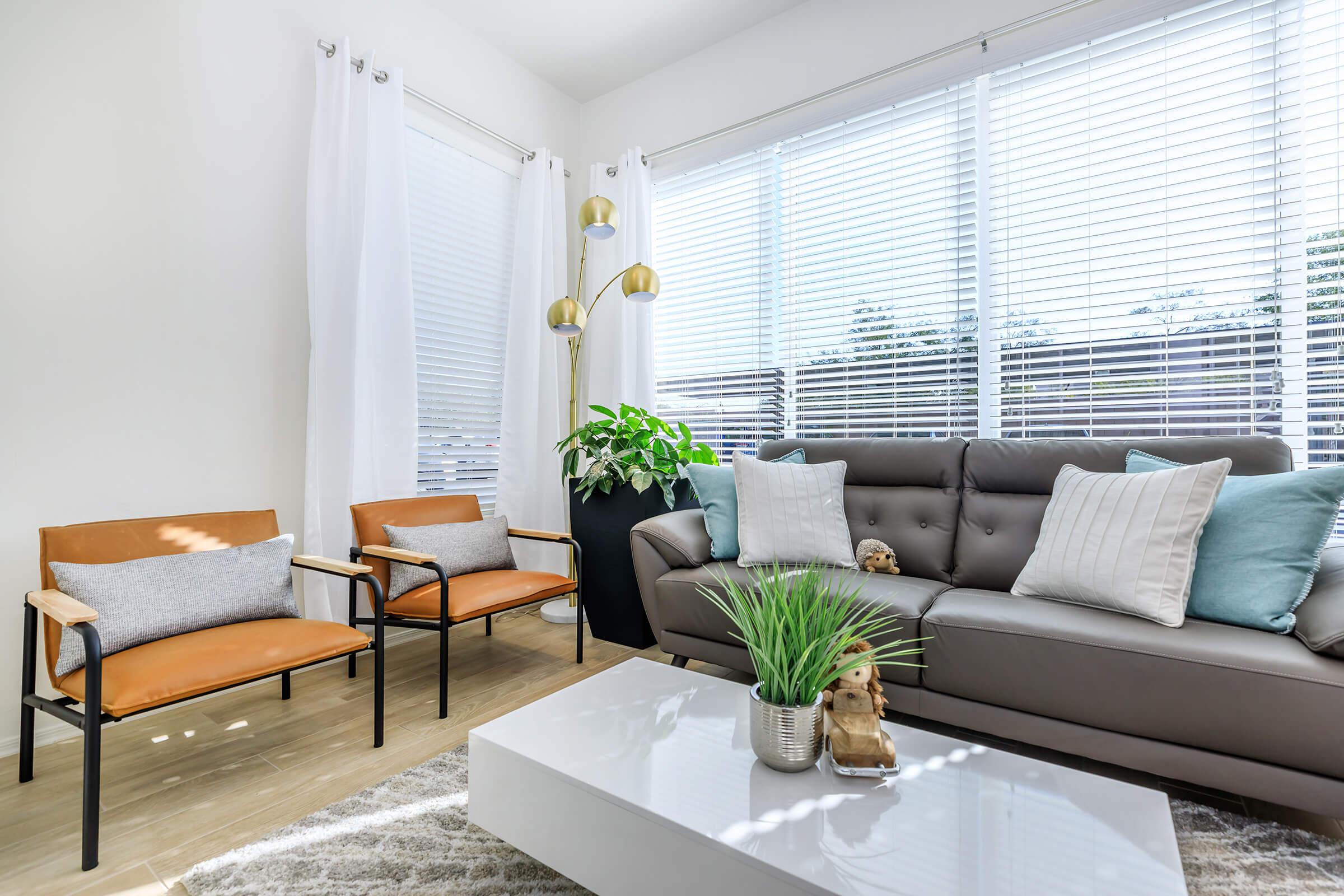 a living room filled with furniture and a large window